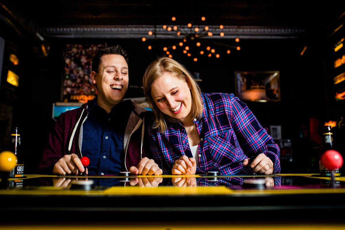 A couple laughs together during a Logan Arcade engagement session.