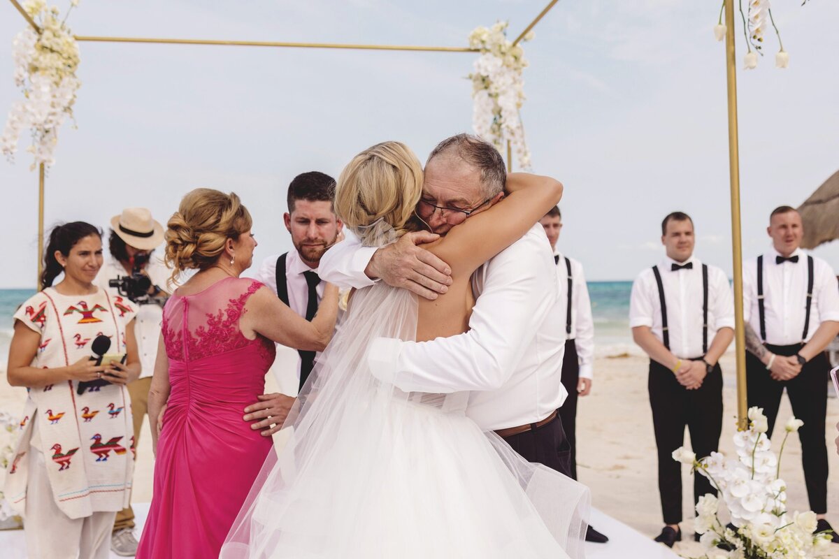 Bride hugging father before wedding ceremony in the Riviera Maya