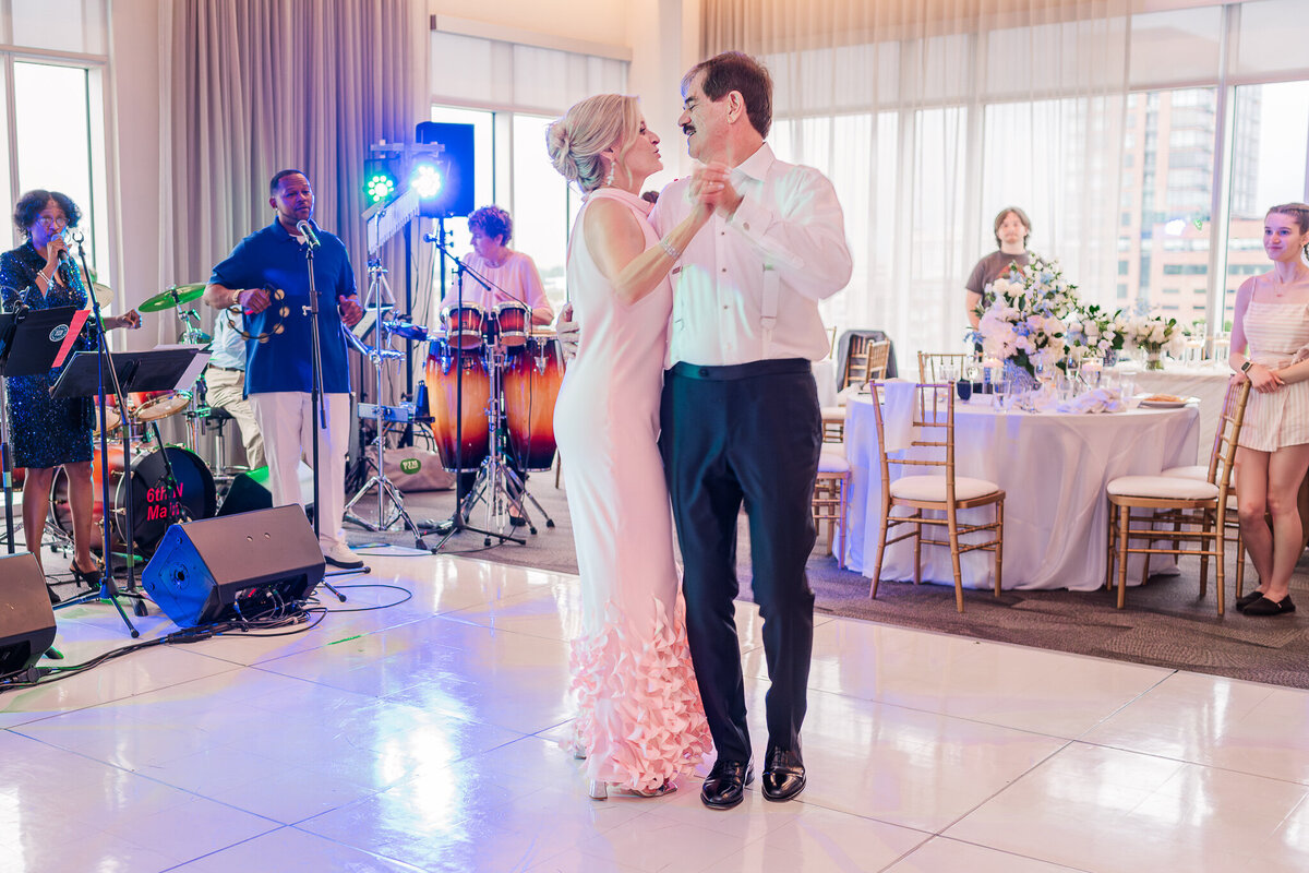 A happy bride and groom sharing a first dance at their Wilmington wedding reception at sunset while enjoying their Wilmington wedding photos