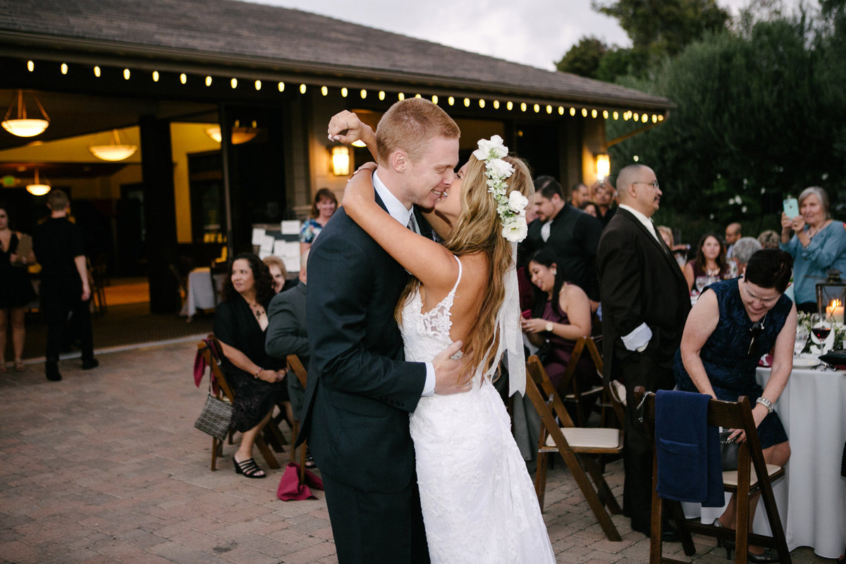 Just married smiling and couple kissing at their reception in San Juan Capistrano