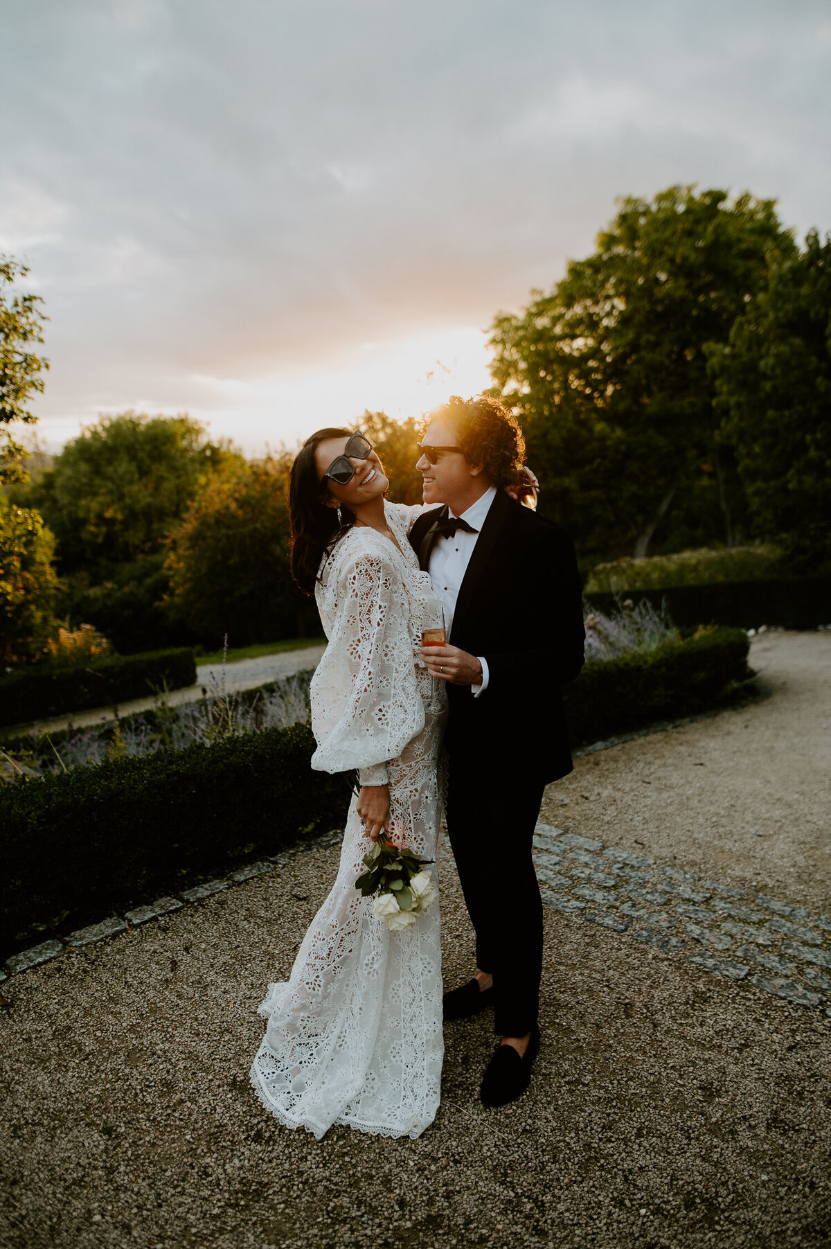 Martine McCutcheon and her husband Jack enjoy the sunset at Beaverbrook in Surrey during their vow renewel. Martine is wearing a white dress and carrying flowers whilst jack is wearing a black tux.