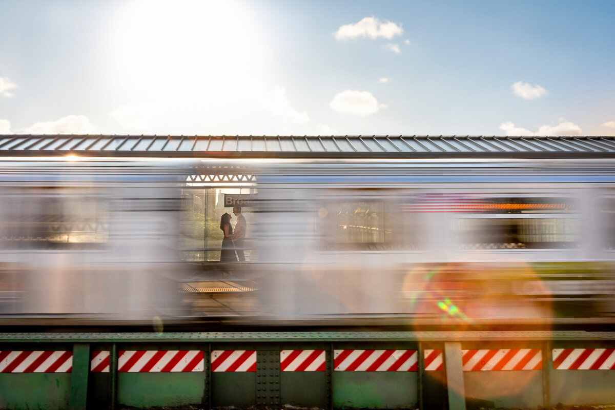 Image of a couple through a moving subway car.