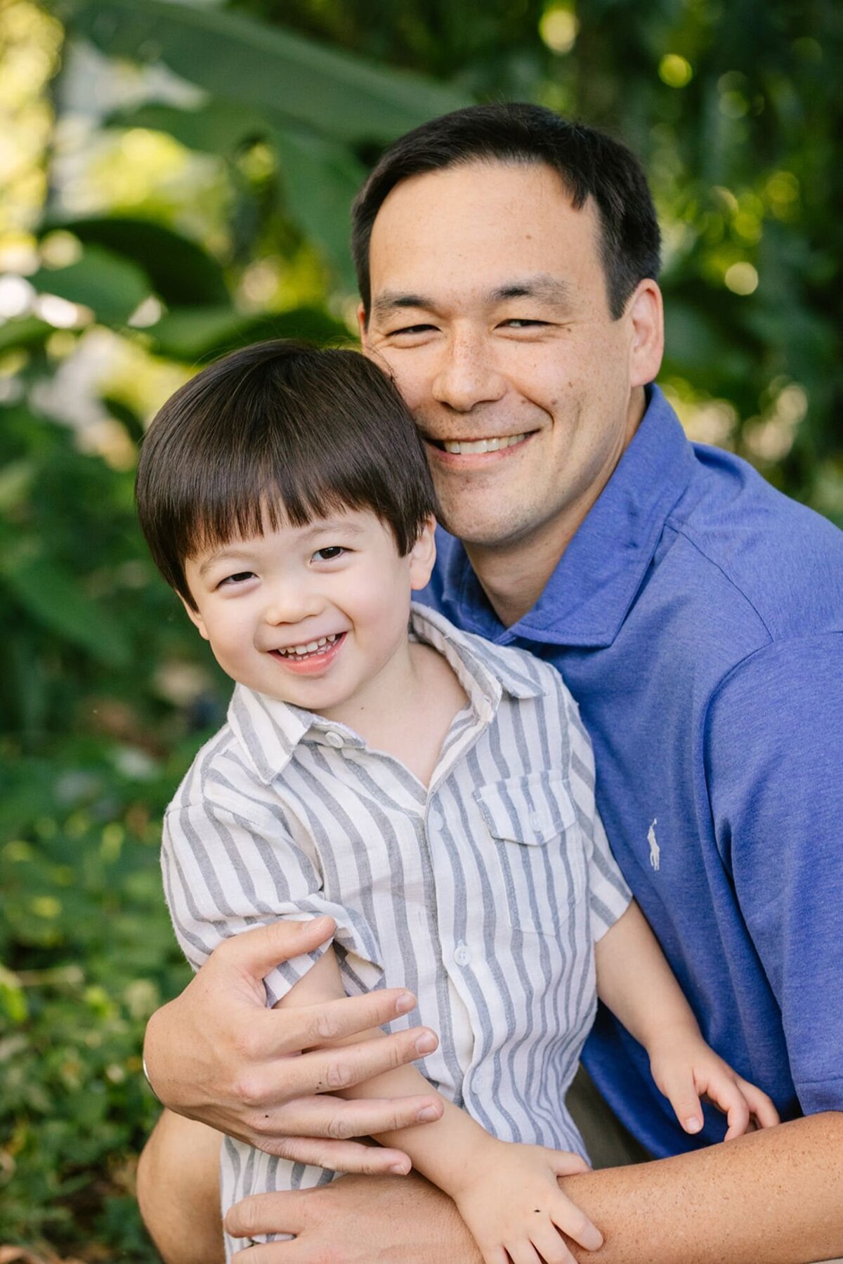 dad and son laughing during photoshoot