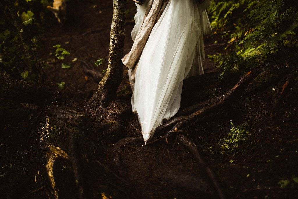 bride snags dress on branch while walking through forest at virgin creek falls