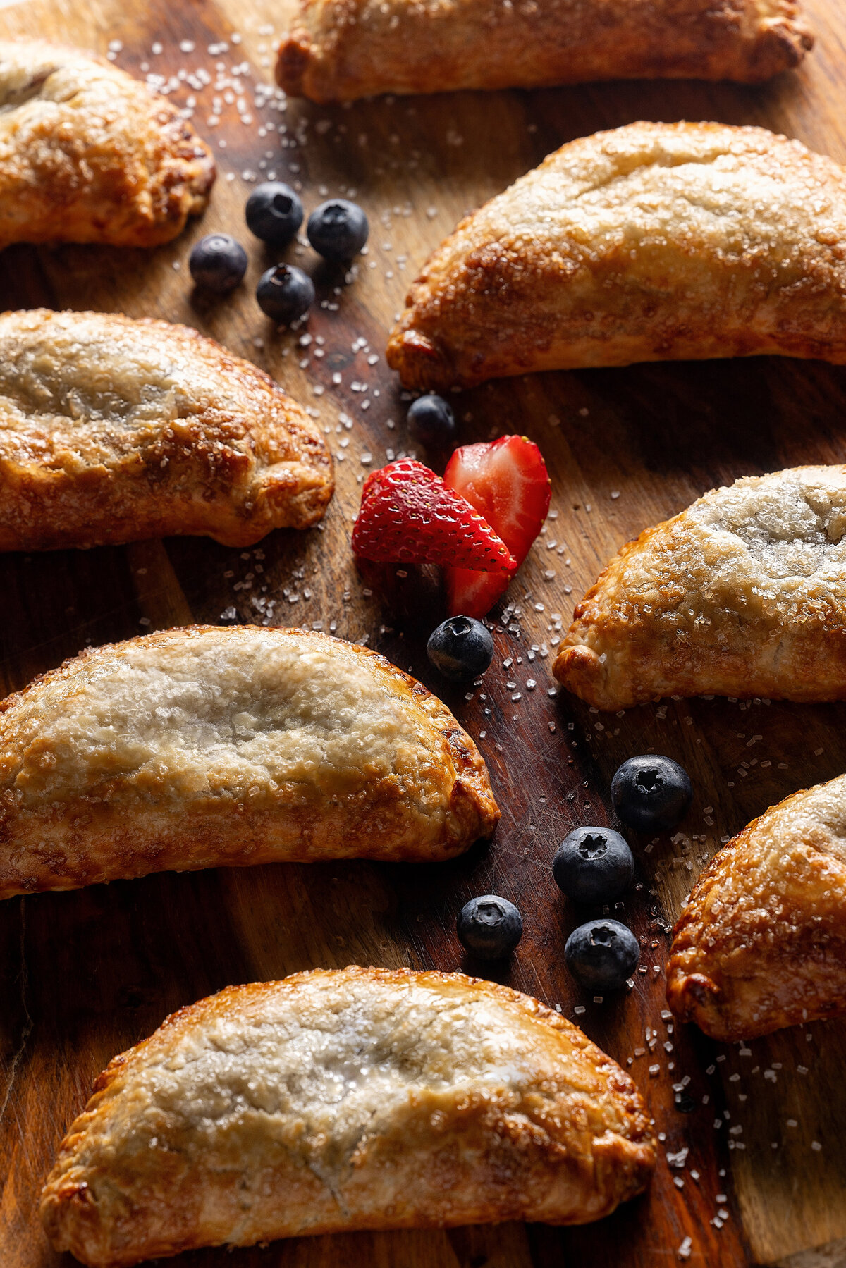 Empanadas laid out with fruit in between