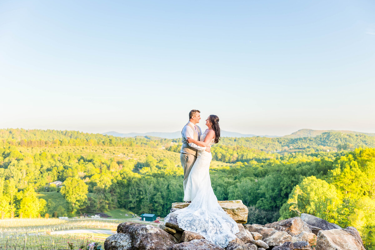 bride and groom embracing at Point Lookout Vineyard