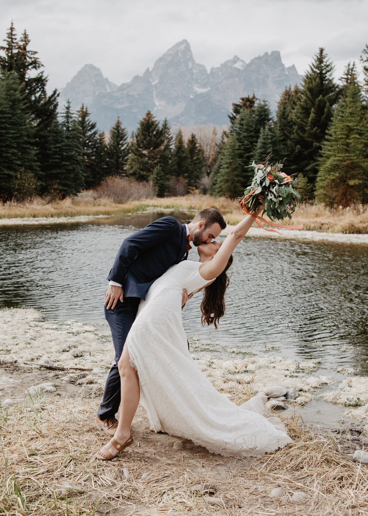 Photographers Jackson Hole capture couple kissing and celebrating recent marriage