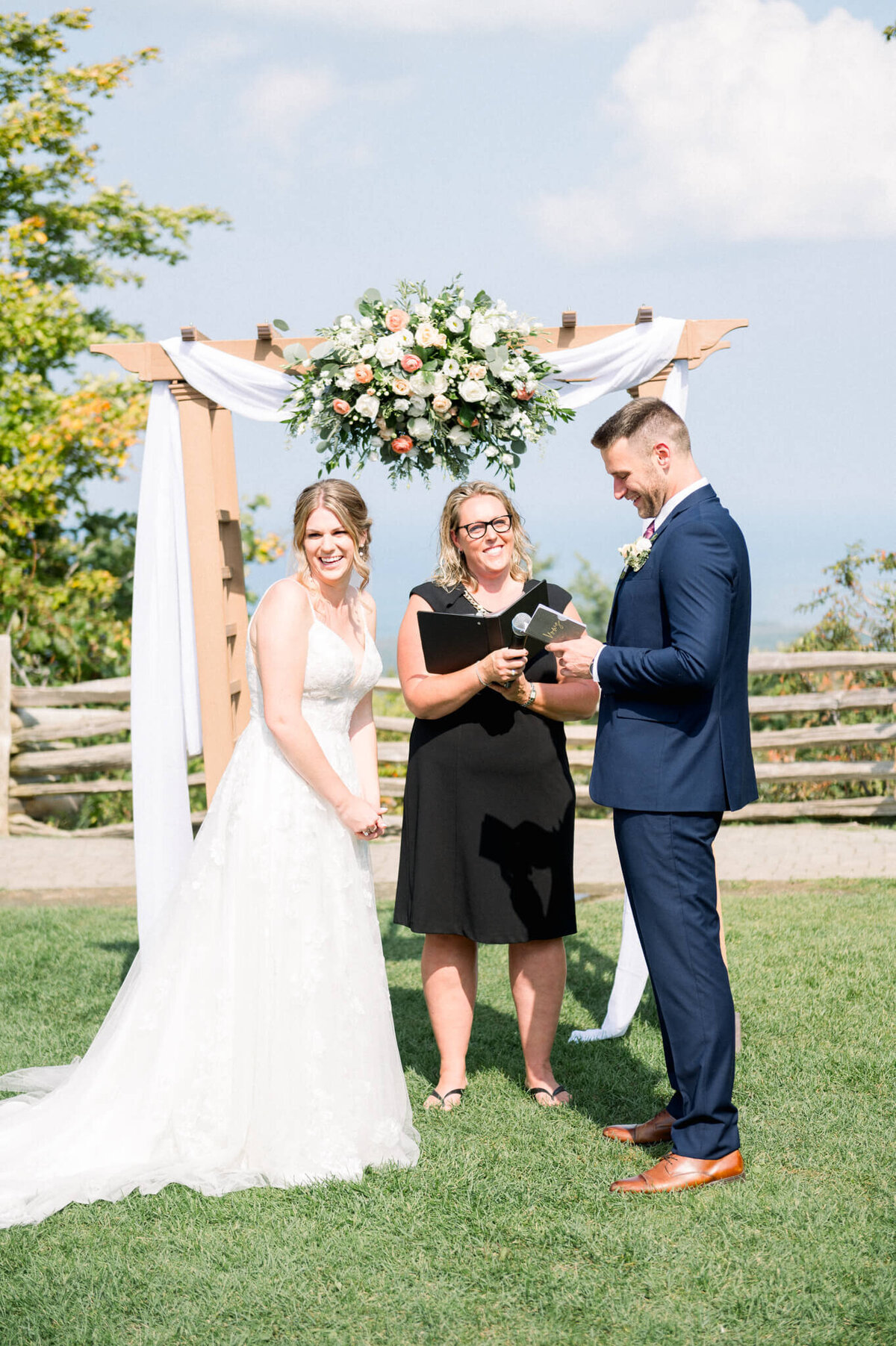 Bride laughing while groom reads vow at their Toronto Wedding