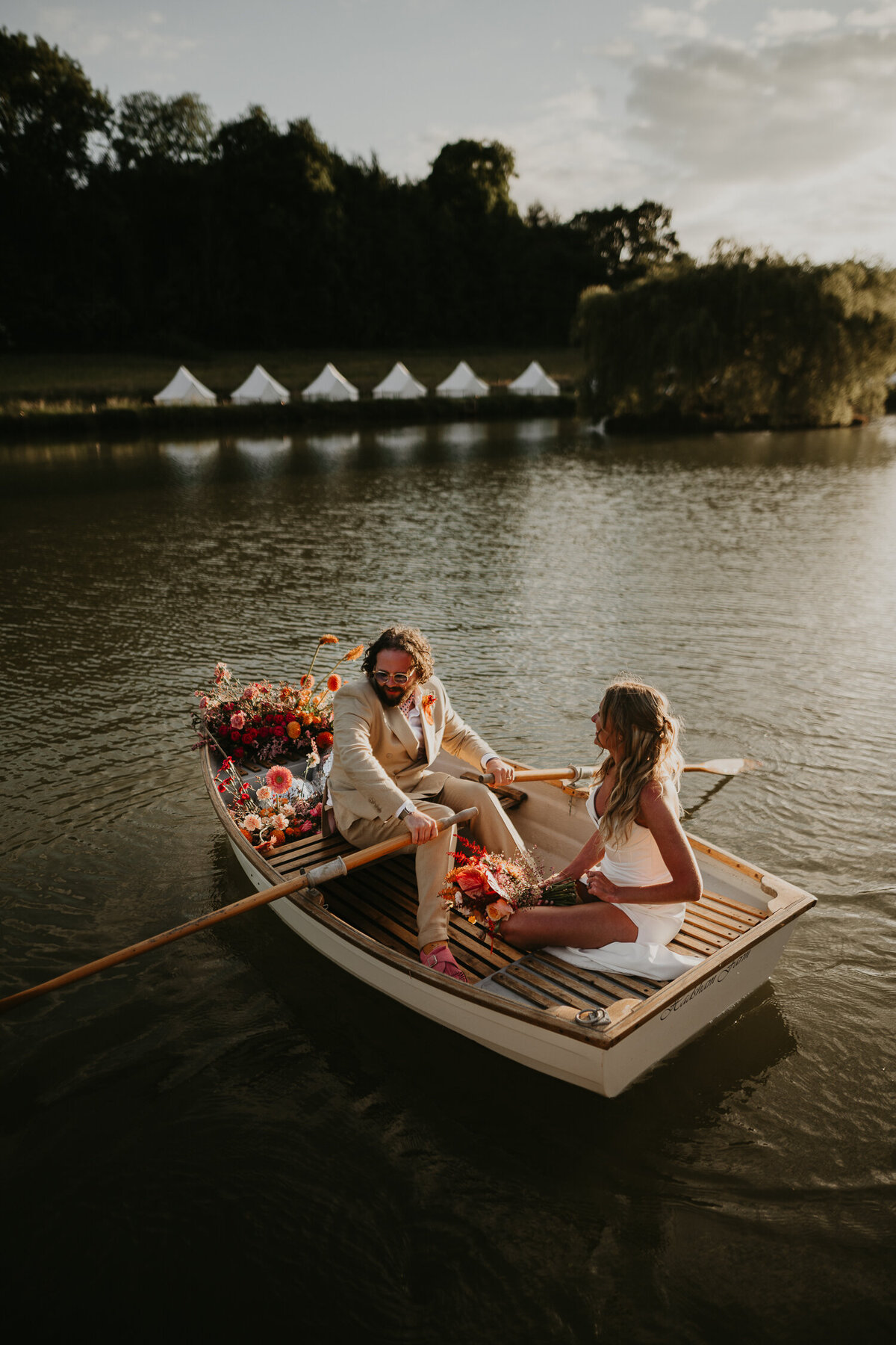 A couple in the boat on the lake at Hadsham Farm Weddings in Banbury.