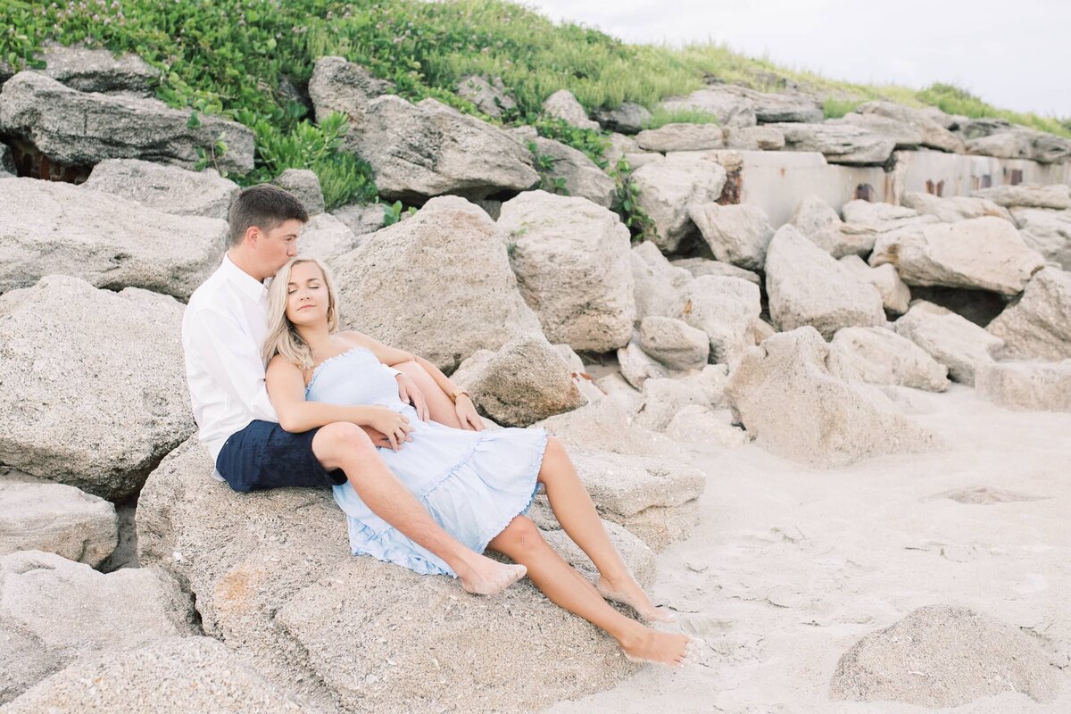 Couple sitting on rocks embracing