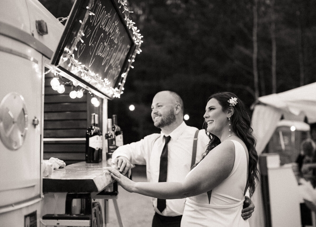 Bride and groom ordering drinks at a mobile bar at their wedding reception