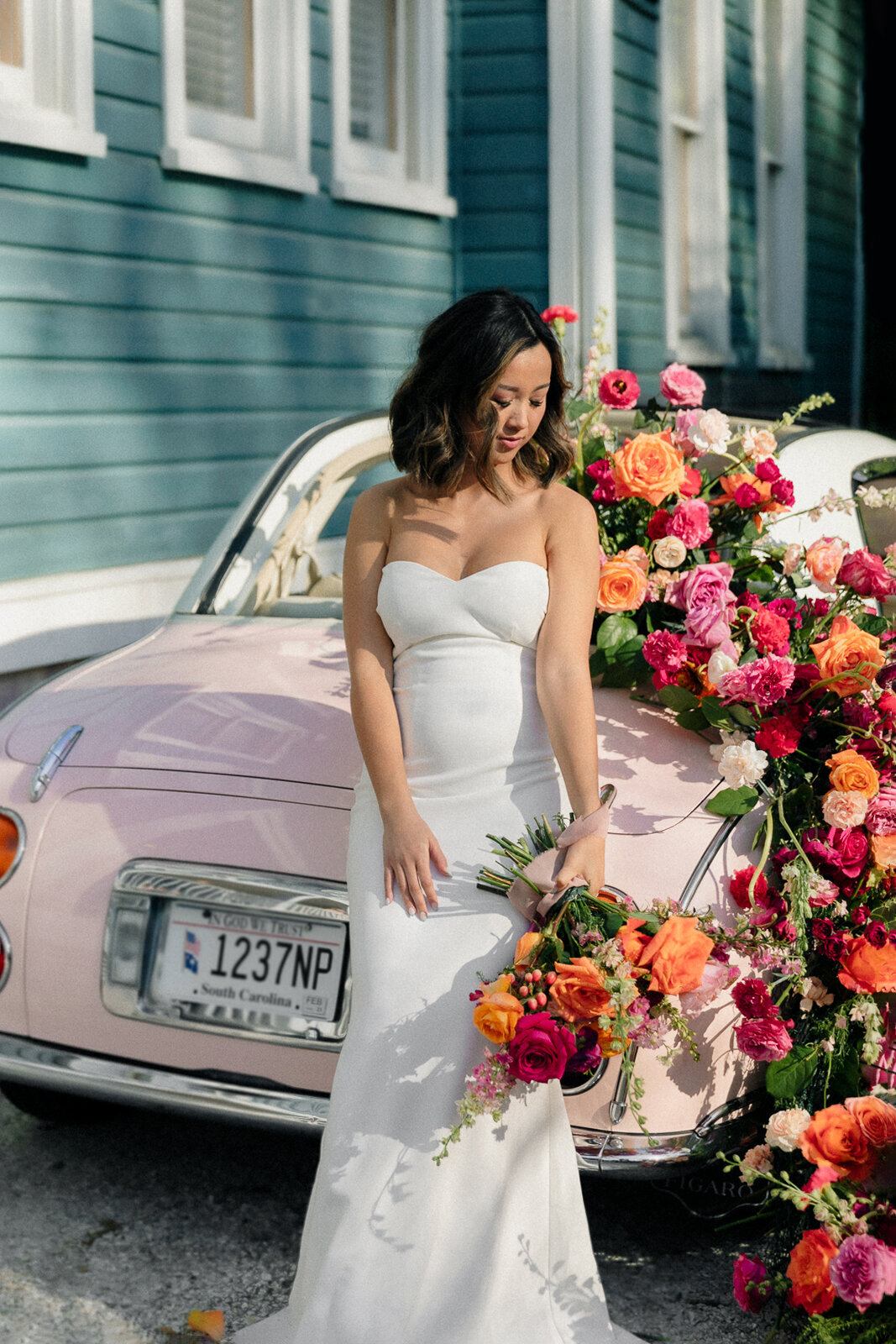bride standing in front of vintage car
