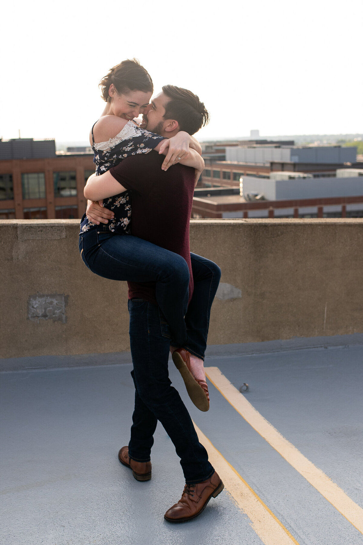 Couple twirls and spins on garage rooftop in Columbus Ohio