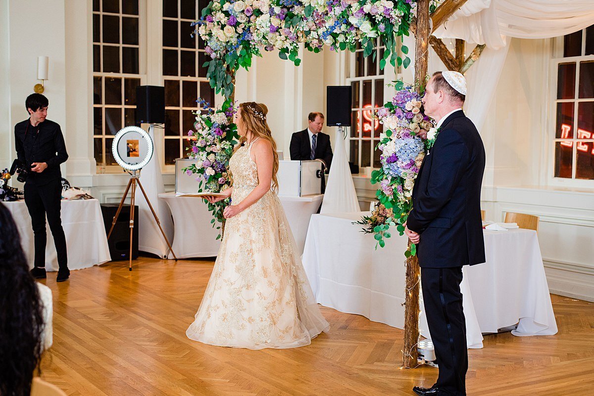 Intimate Jewish wedding in Nashville at Noelle Hotel with bride and groom walking over to the photo booth for a picture