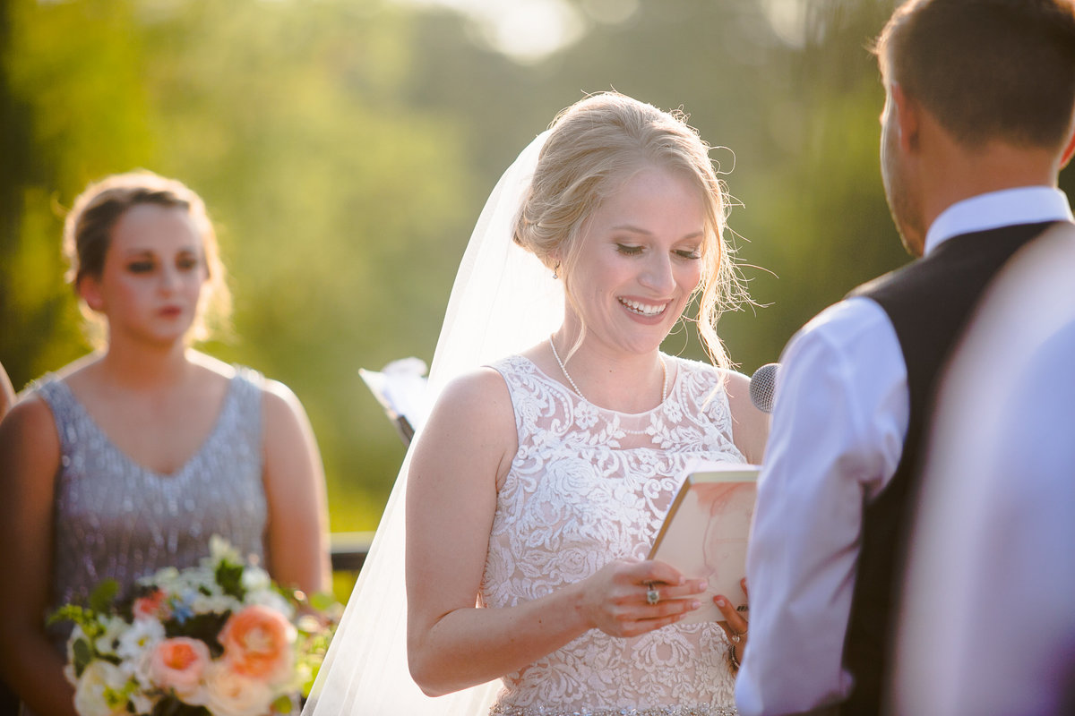 Bride and Groom say their vows at Chandler Hill Vineyard in Missouri.