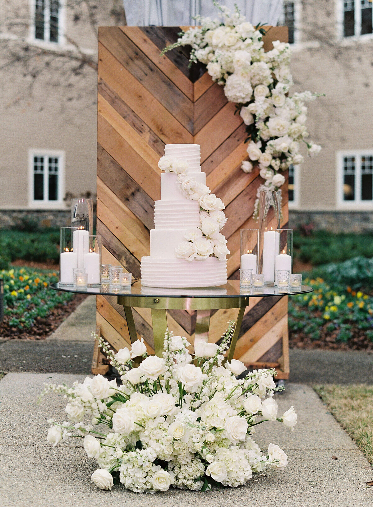 white wedding cake with white roses and hydrangea