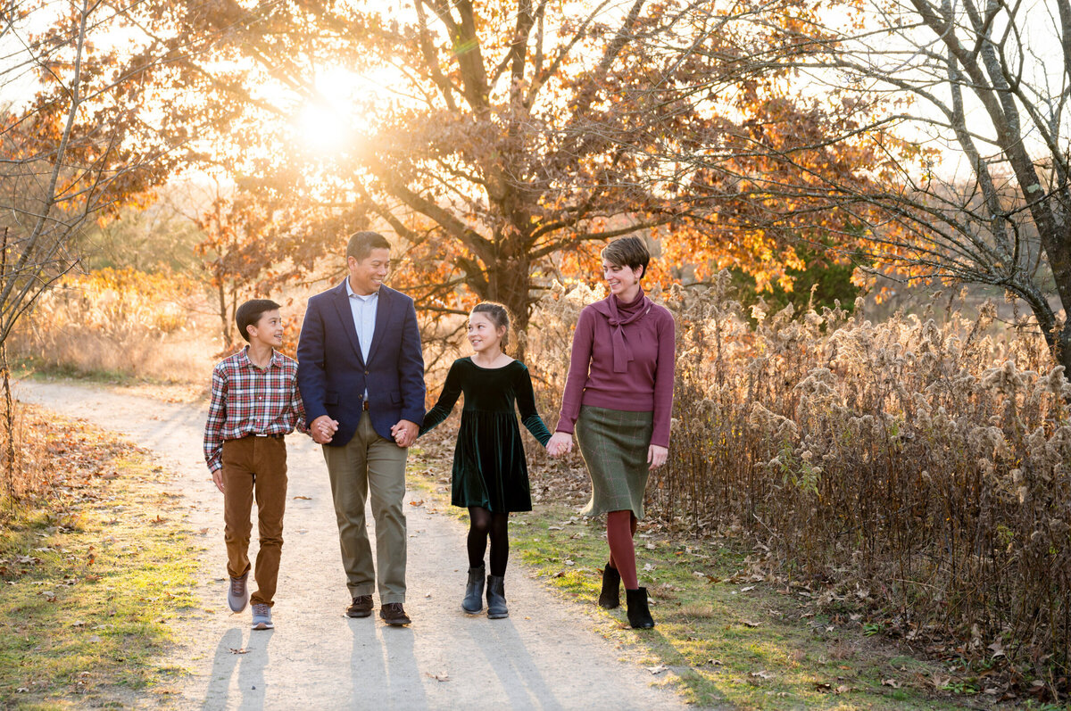 Family of four walking through a park in Cherry Hill, New Jersey
