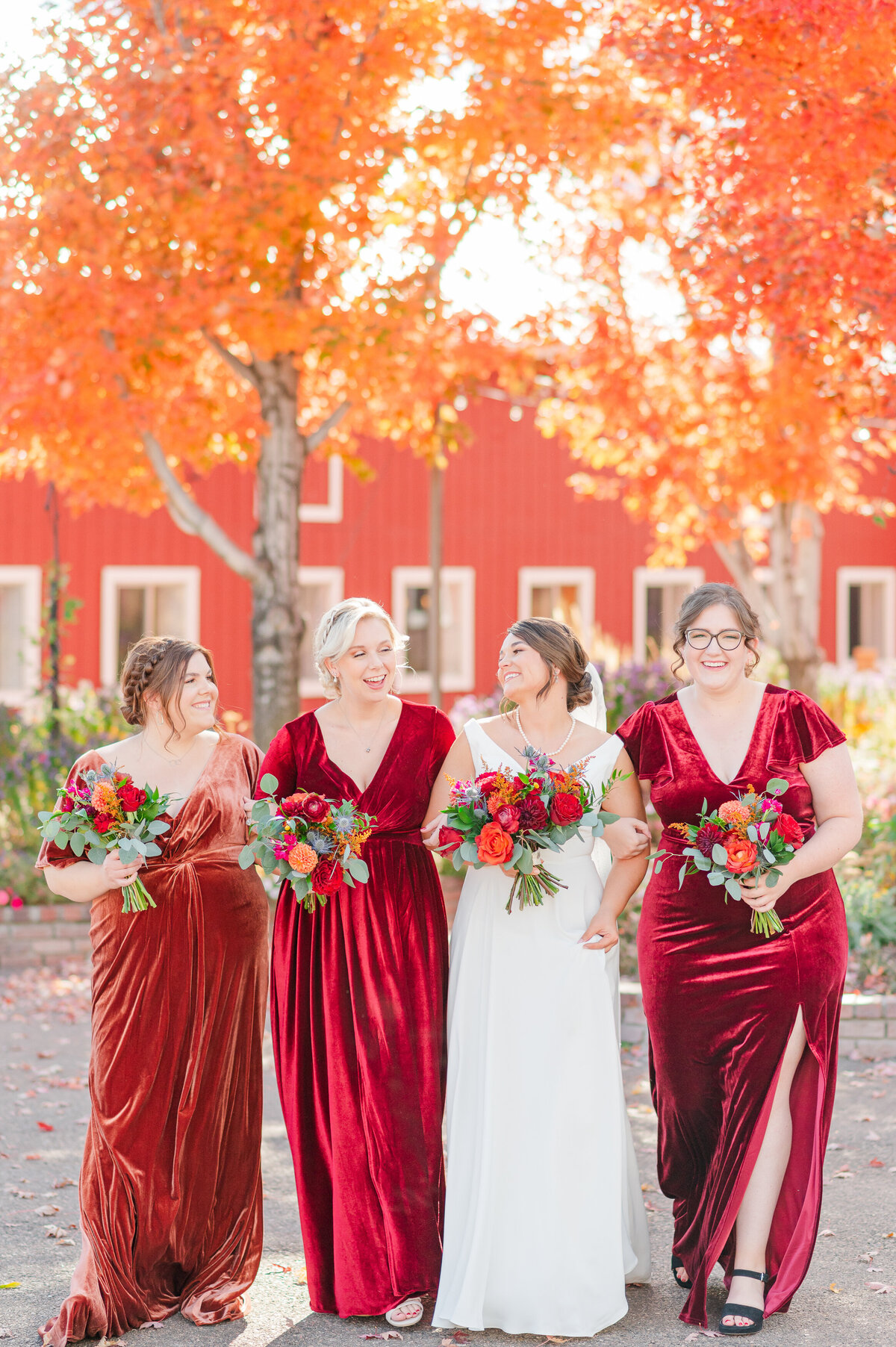 Bride and bridesmaids wearing fall colors during a fall wedding at Crooked Willow Farms.