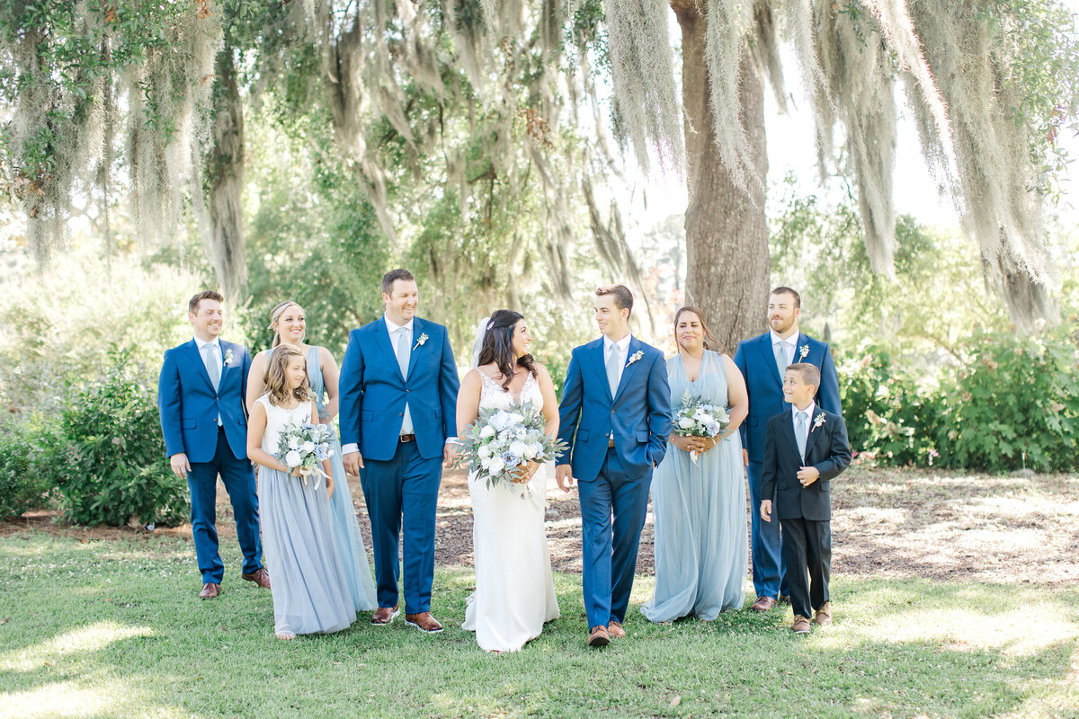 Wedding party walks outdoors at the Gadsden House by Karen Schanely