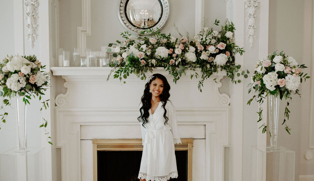 bride posed by fireplace