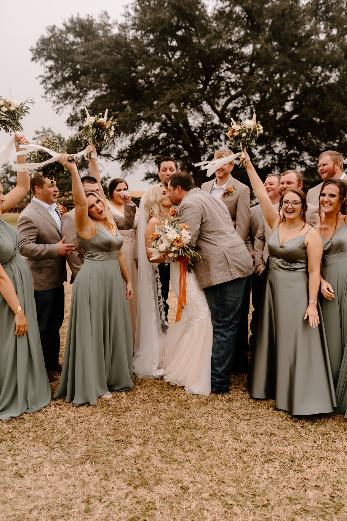 bridal party celebrate with bride and groom