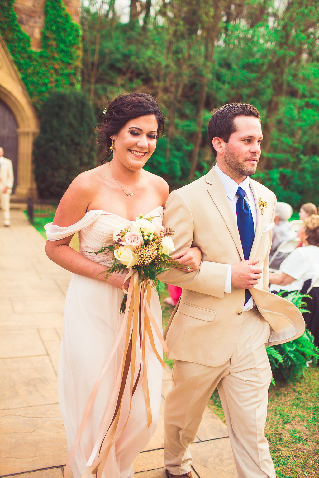 Wedding Photograph Of Bridesmaid in Peach Dress and Groomsman in Light Brown Suit Walking Down The Aisle Los Angeles