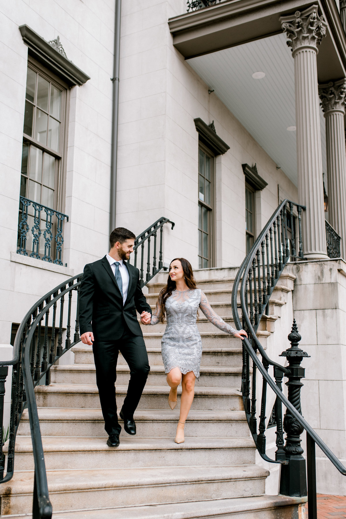 Couple walking down stairs during engagement session Savannah