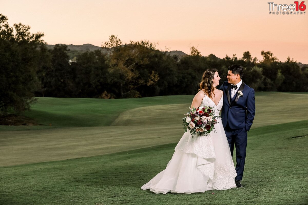 Bride and Groom gaze into each other's eyes during photo shoot on the golf course at the Coto de Caza Golf & Racquet Club