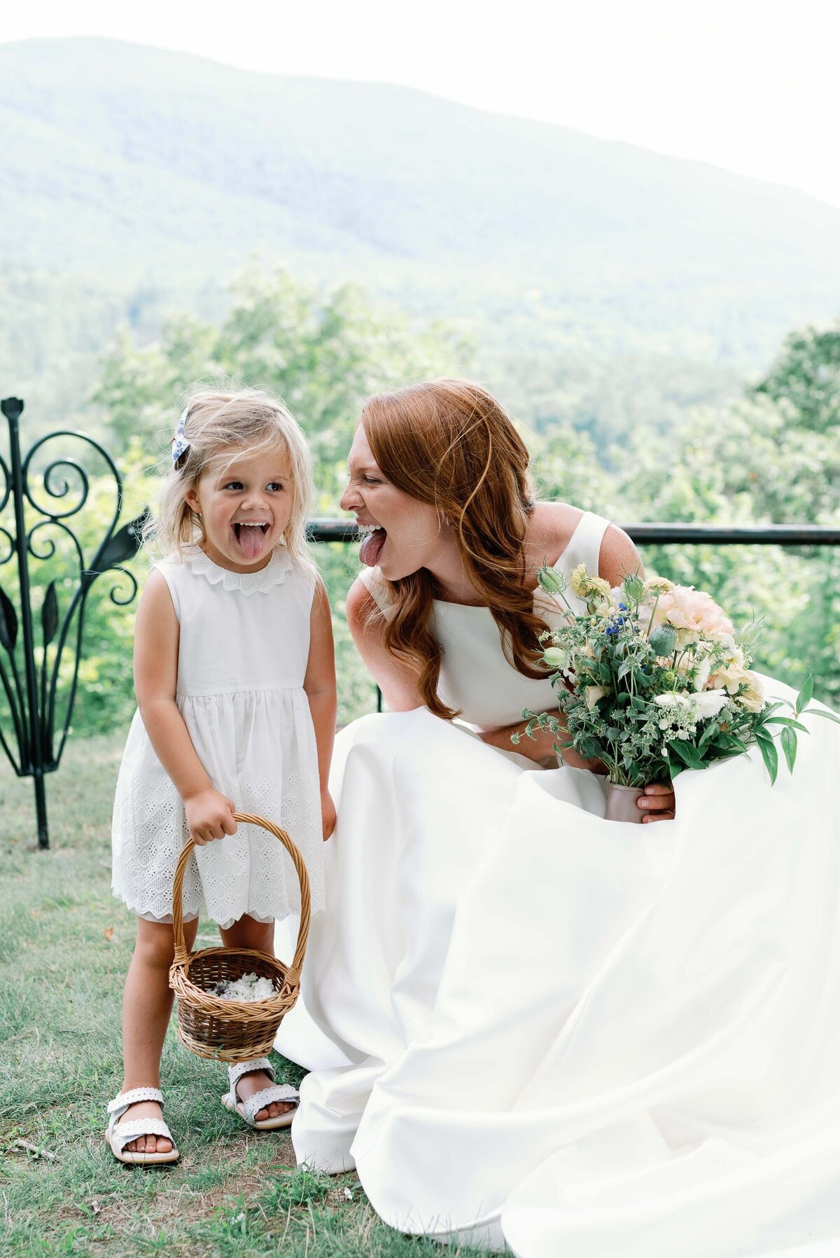 bride and flower girl make silly faces at wilburton inn wedding