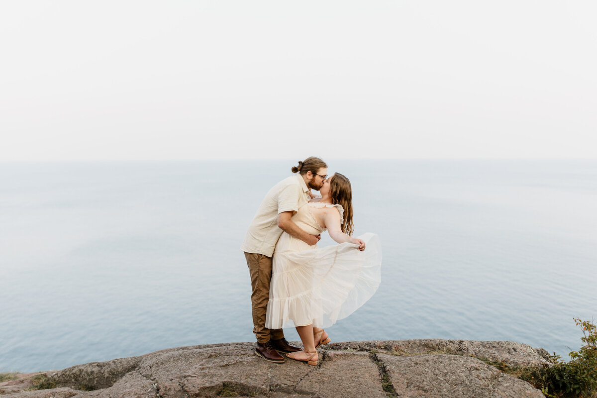 A couple takes their engagement photos at Palisade Head in Silver Bay, MN up the North Shore of Minnesota surrounded by Lake Superior. Photo taken by Minnesota Wedding Photographer, Morgan Elizabeth Photography www.morganelizabethphoto.com @morganelizabethphotos