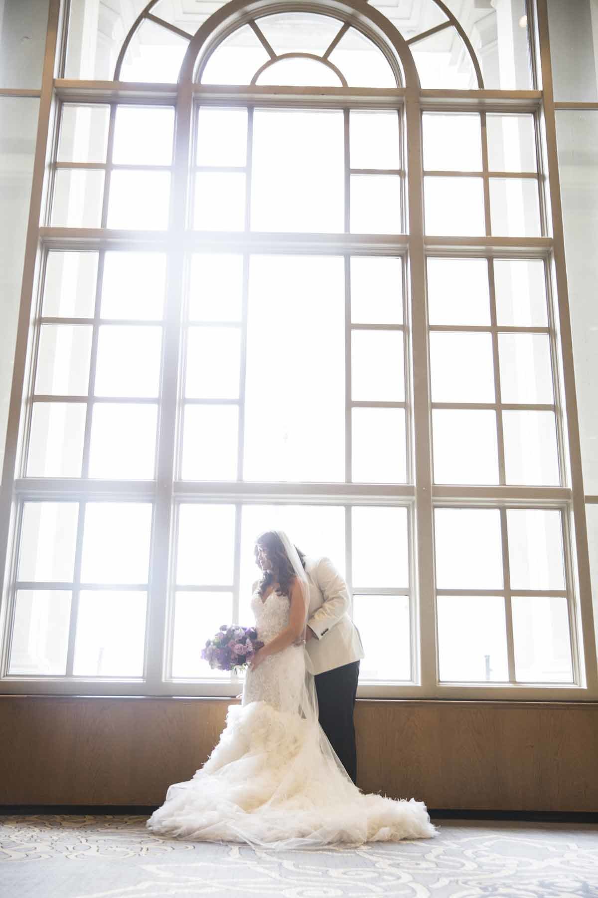 Our bride and groom posing in the sunlight.