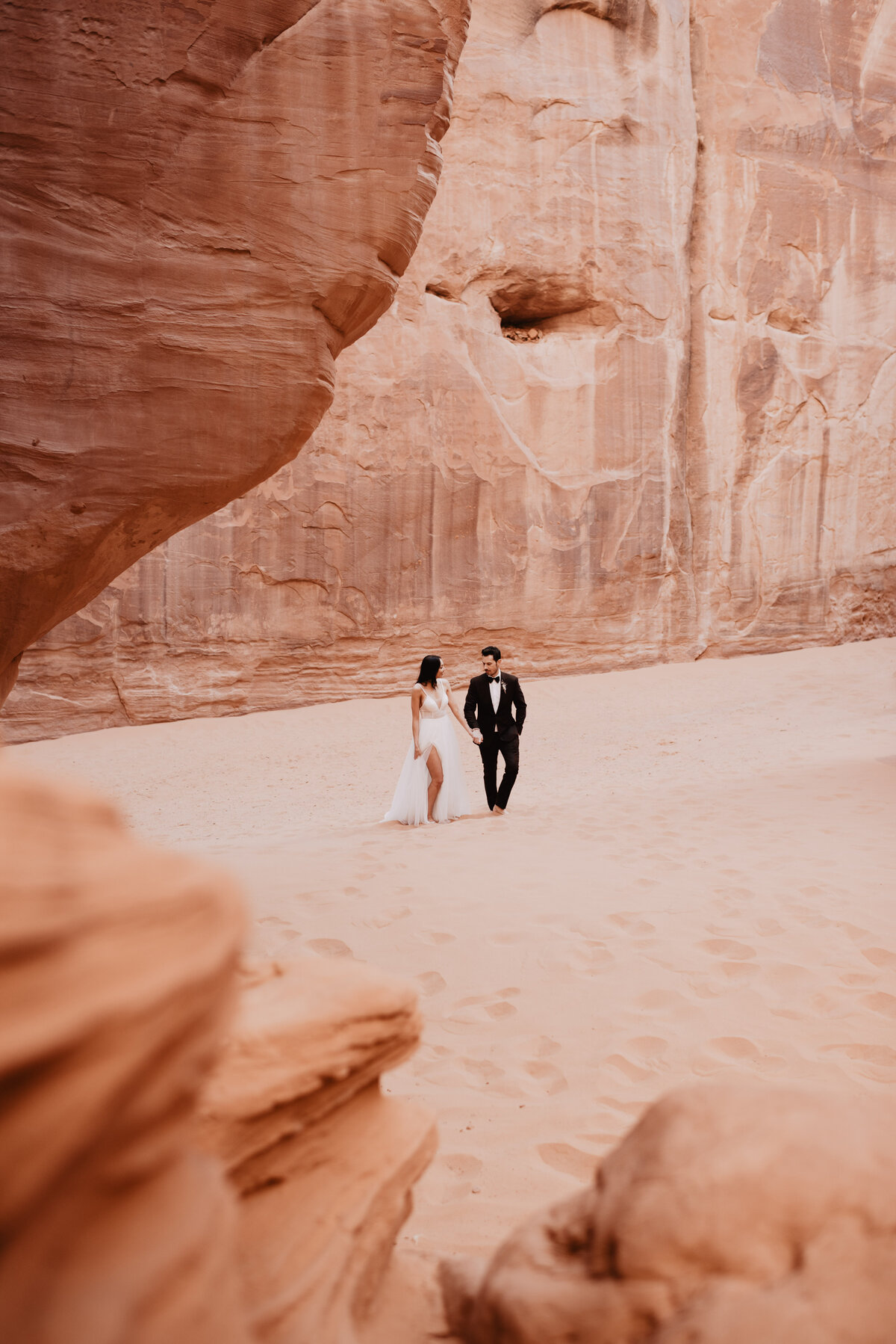 Utah elopement photographer captures couple walking through Arches National Park