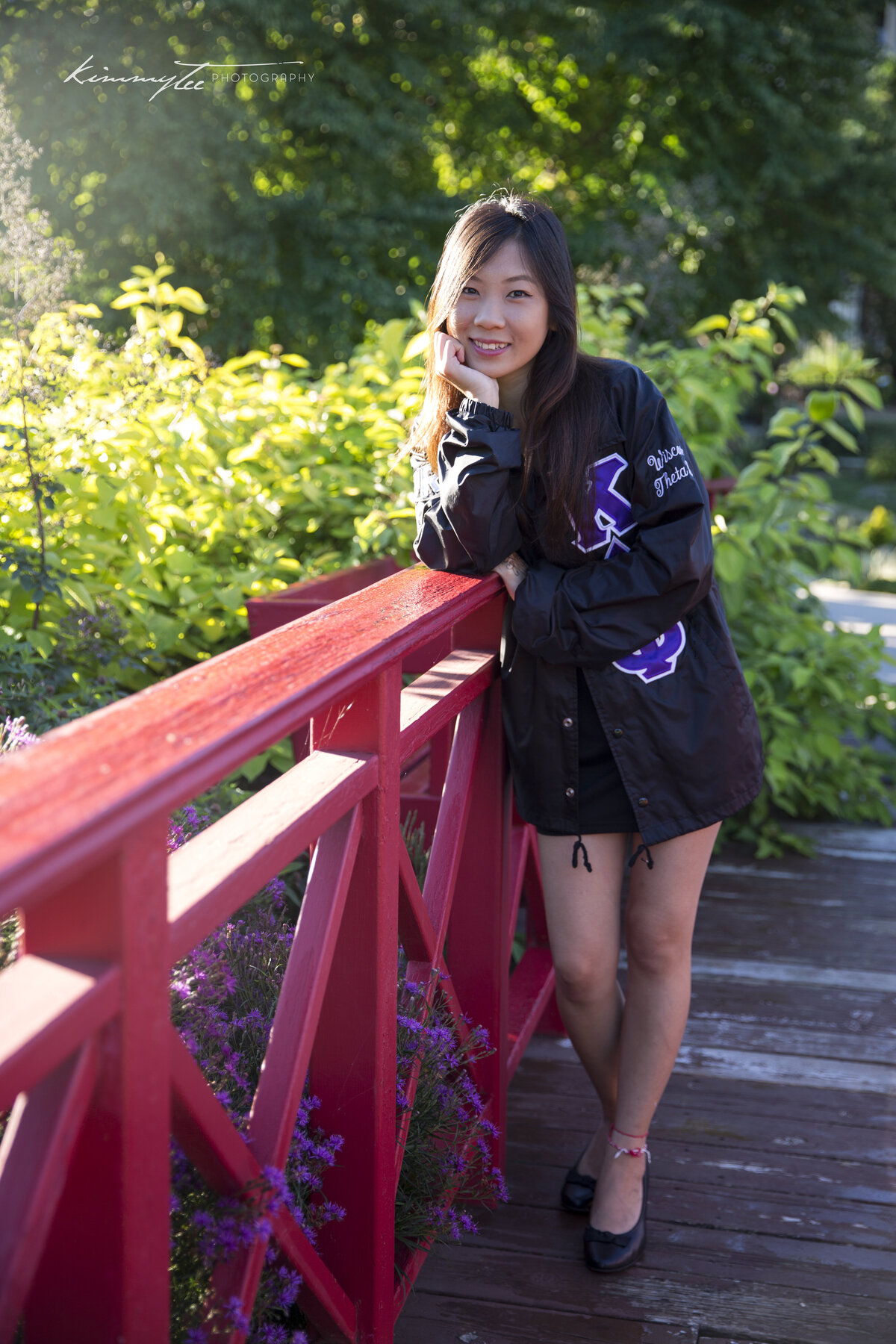 Smiling sorority girl standing on a bridge