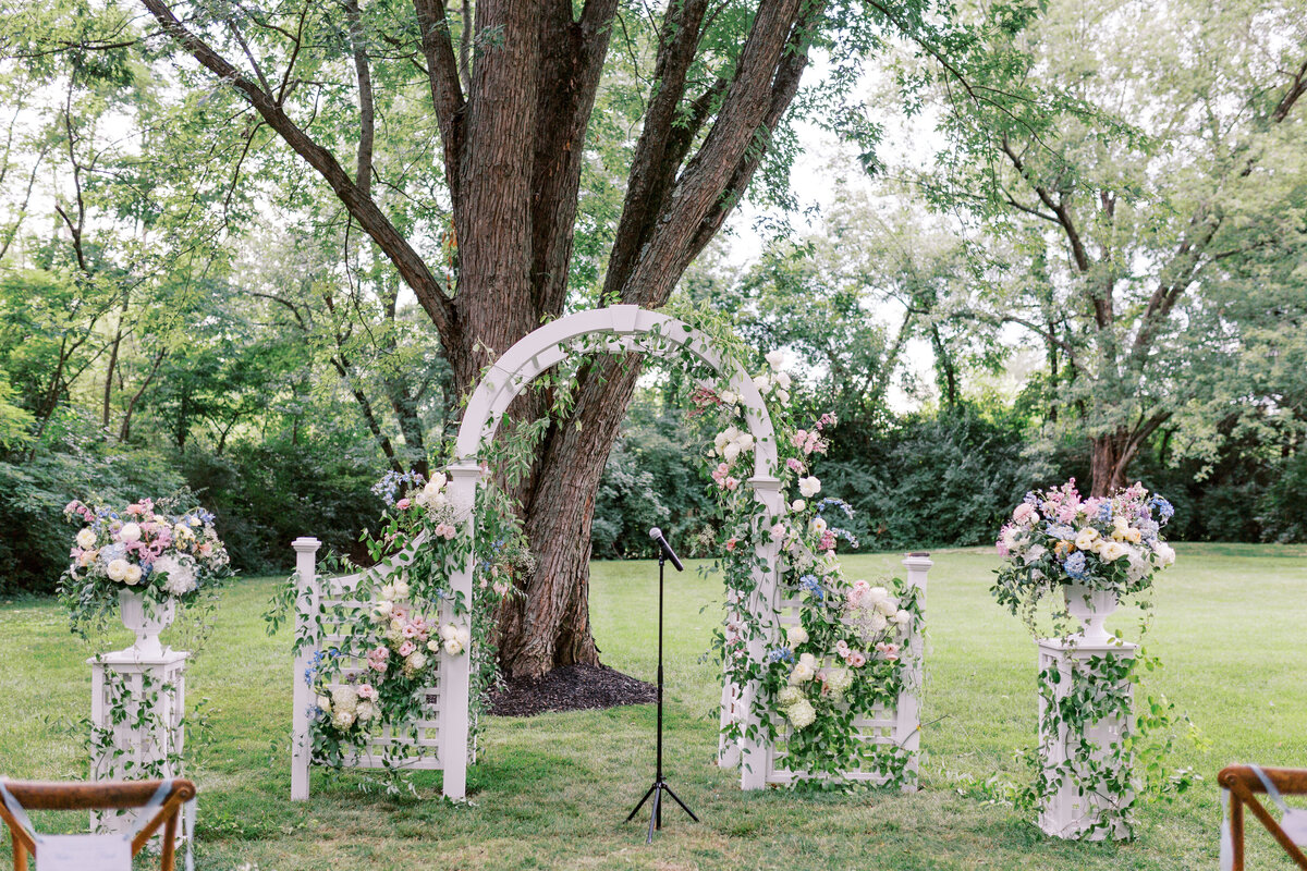Floral arrangements placed on pedestals for wedding ceremony
