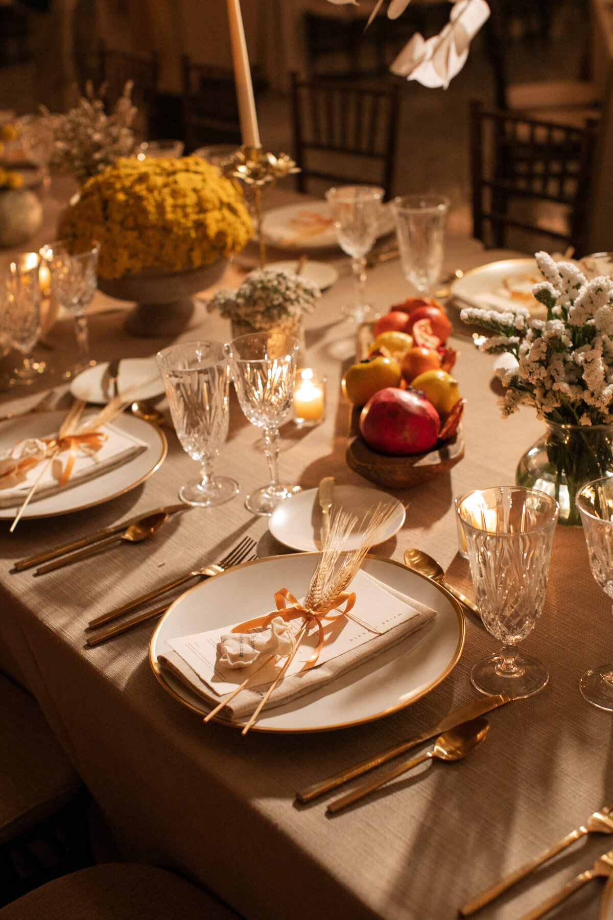 Gold flatware and stone plates with cut crystal wine glasses.