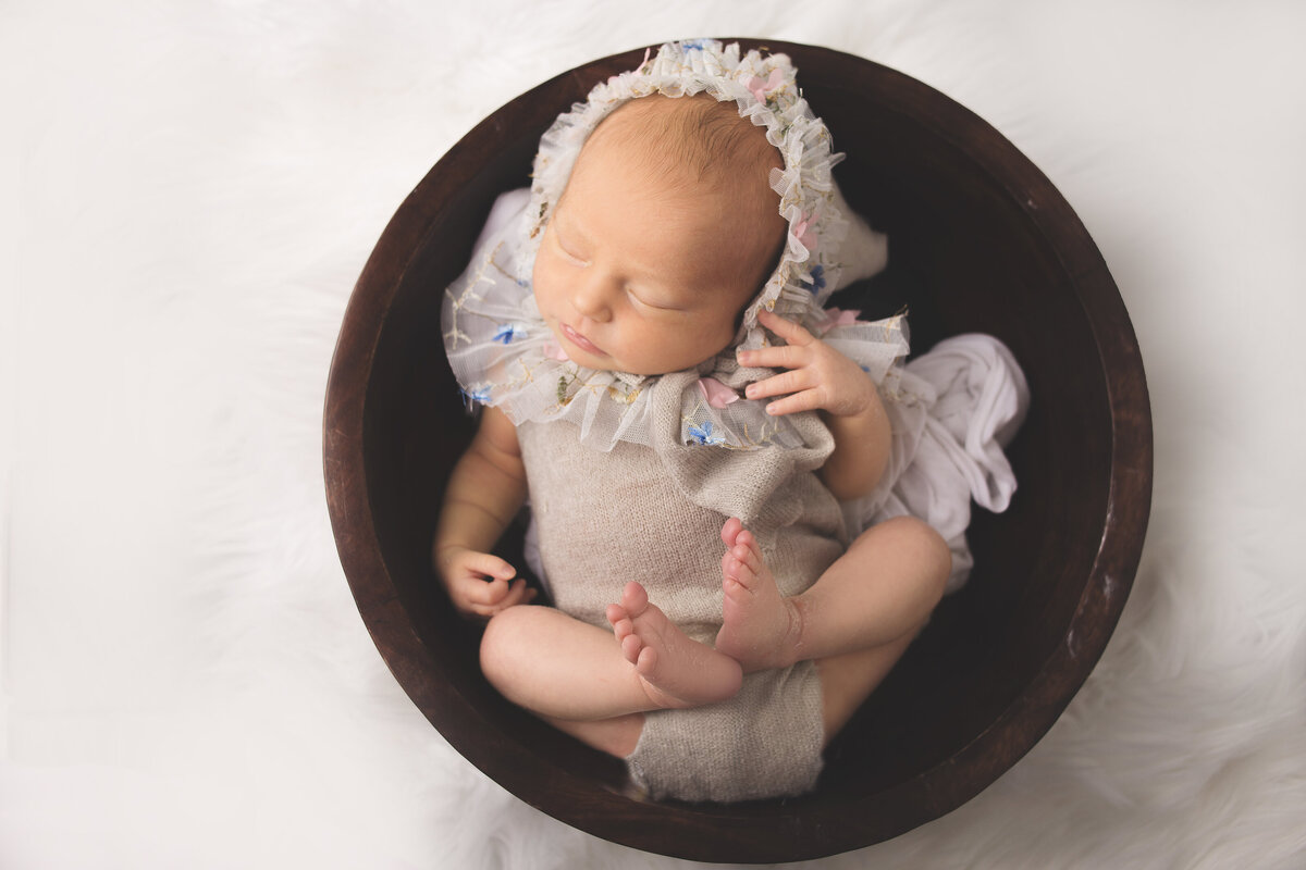 Newborn baby girl wearing grey bon