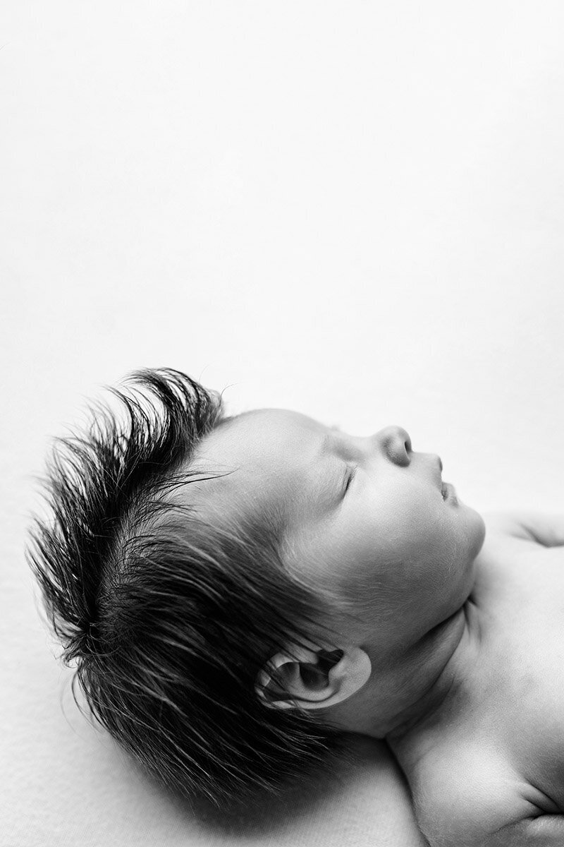 Profile photo of newborn with lots of hair