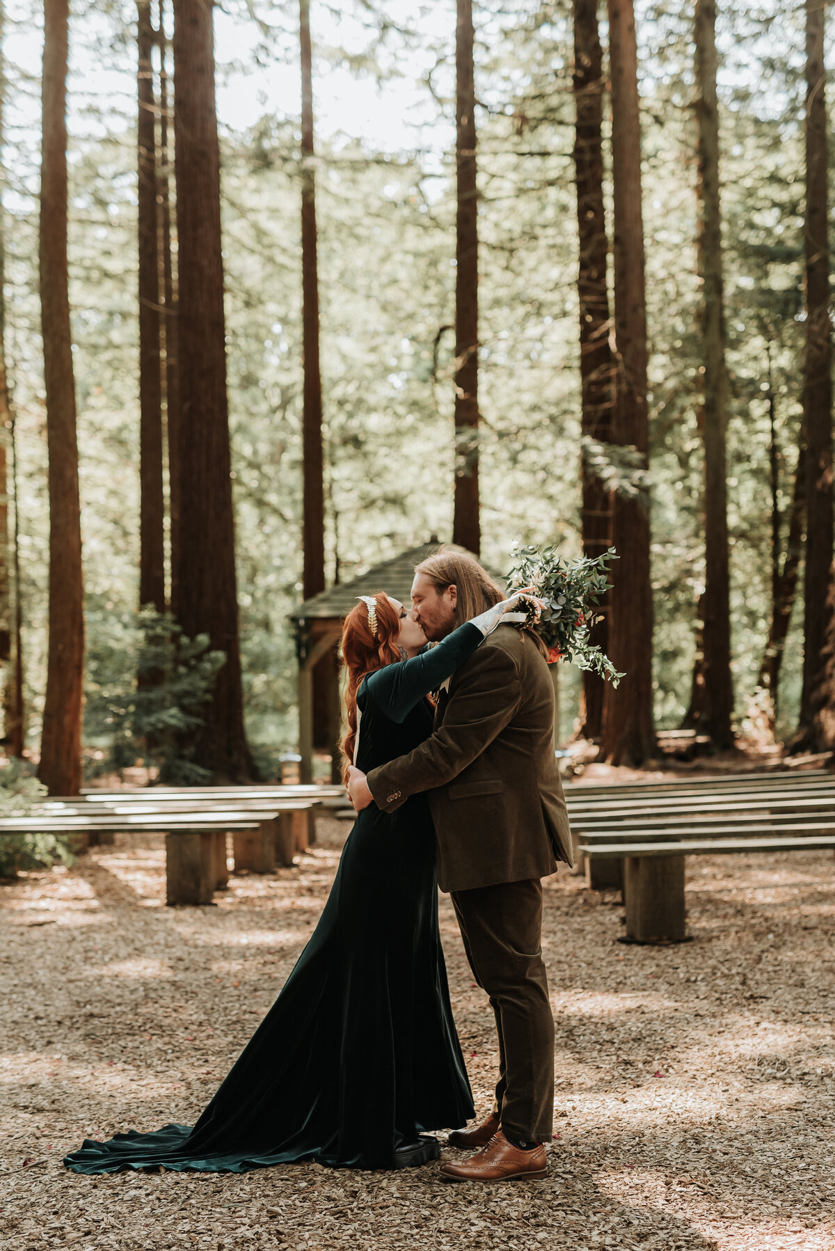 Bride and Groom kiss in the Redwoods at their relaxed forest wedding at Two Woods Estate