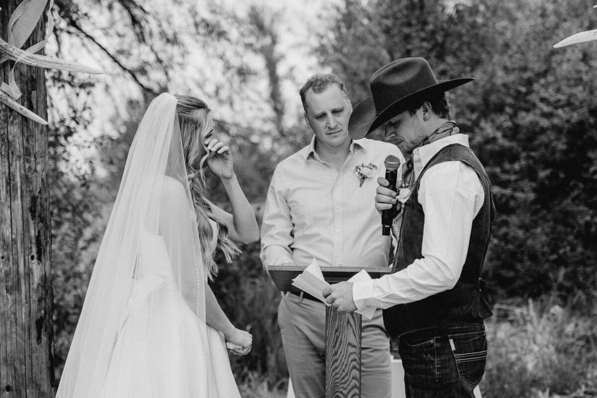 The bride cries while the groom reads his wedding vows in Ellensburg, Washington.