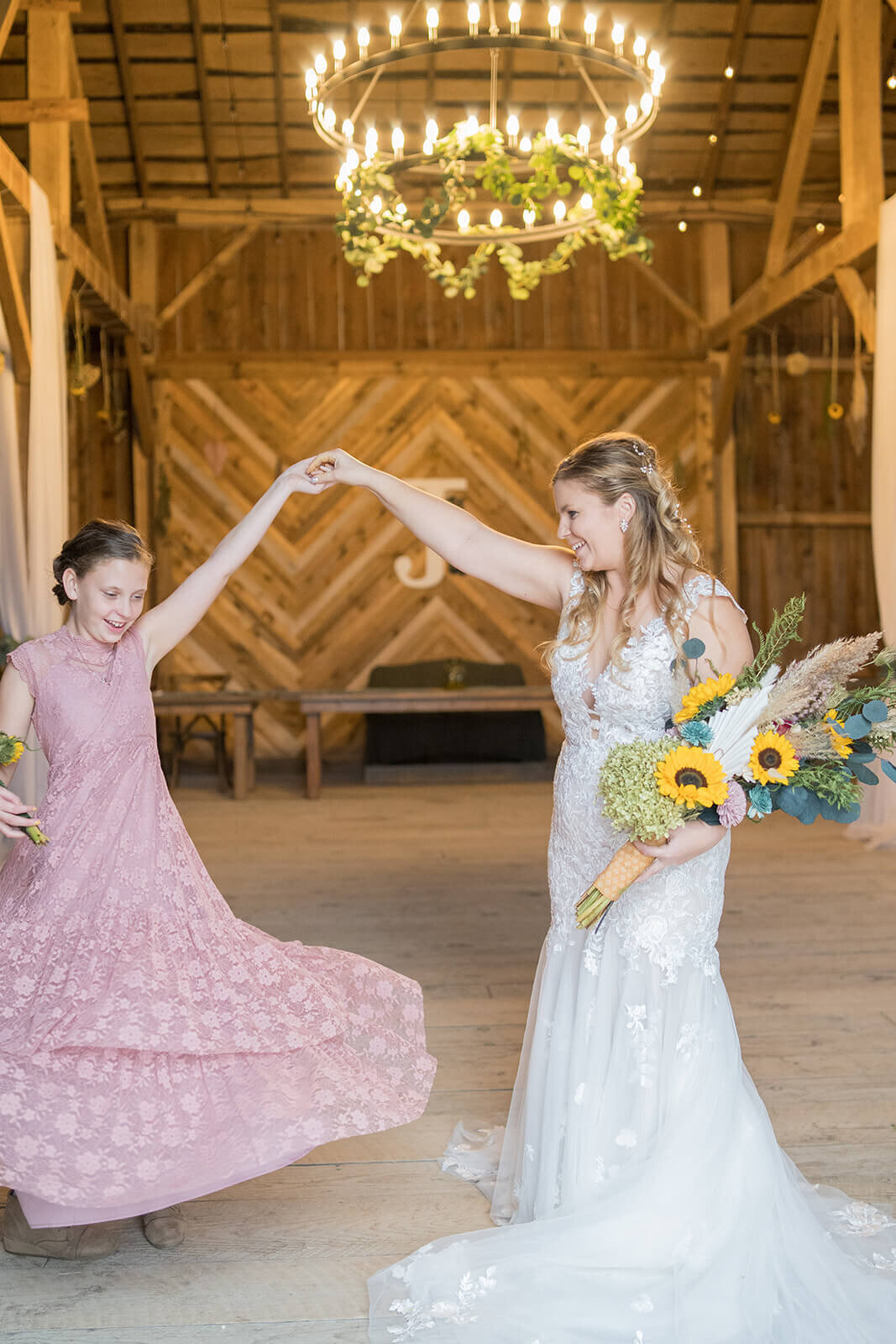 mom and daughter twirling in their dresses after wedding