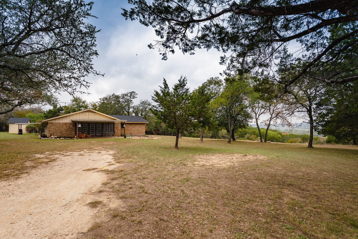 Covered patio with seating and large yard at this three-bedroom, two-bathroom ranch house for 7 with incredible hiking, wildlife and views.