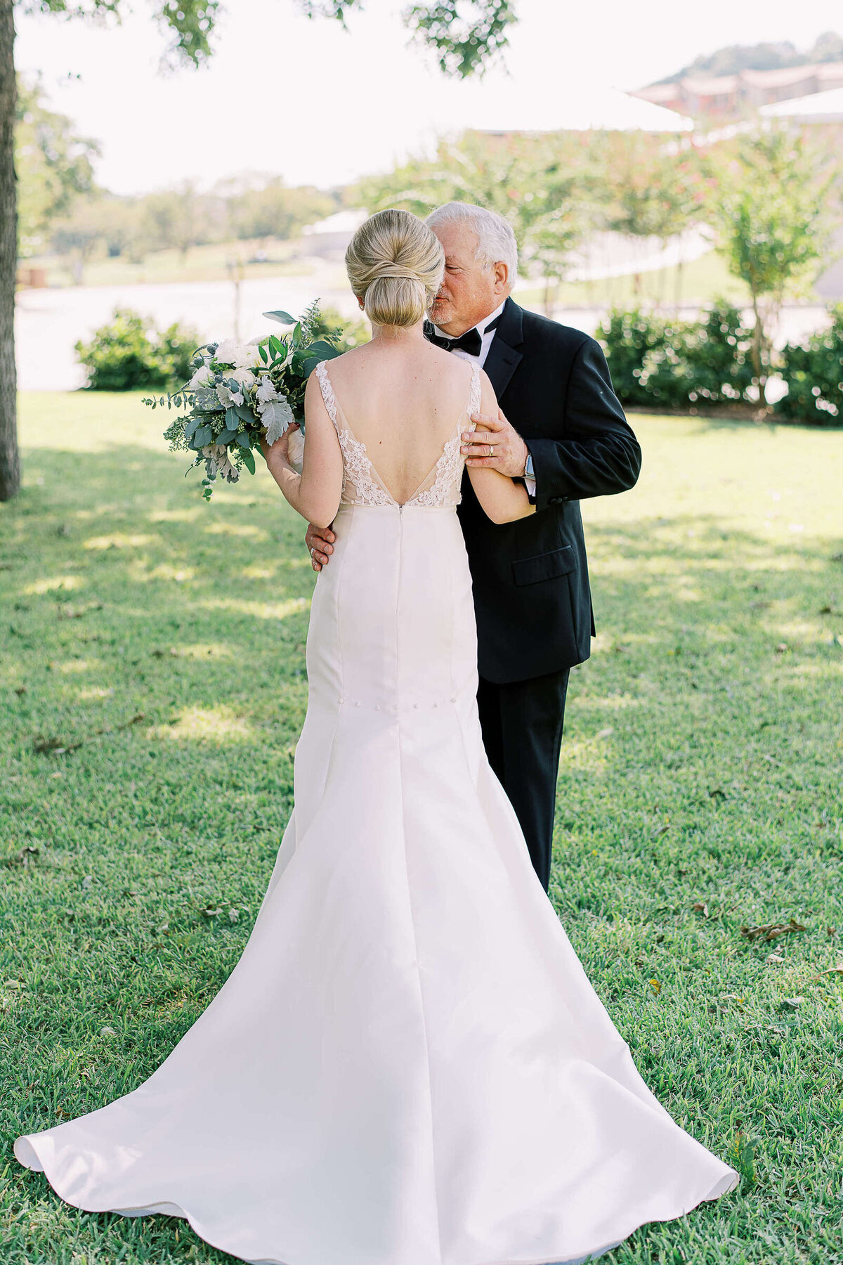 Bride's father embraces his daughter before she walks down the aisle