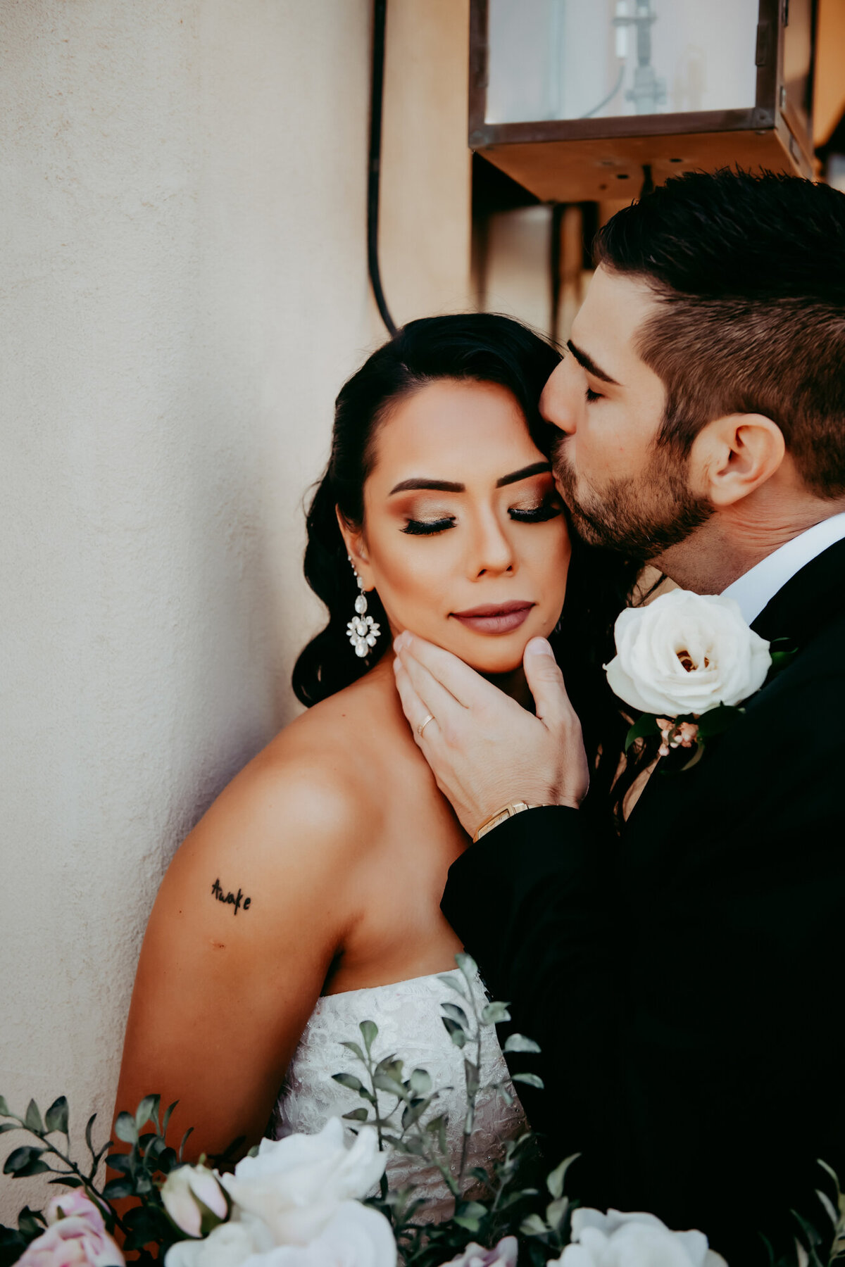 Couples Photography, Groom kisses bride on side of face as she affectionately accepts with eyes closed