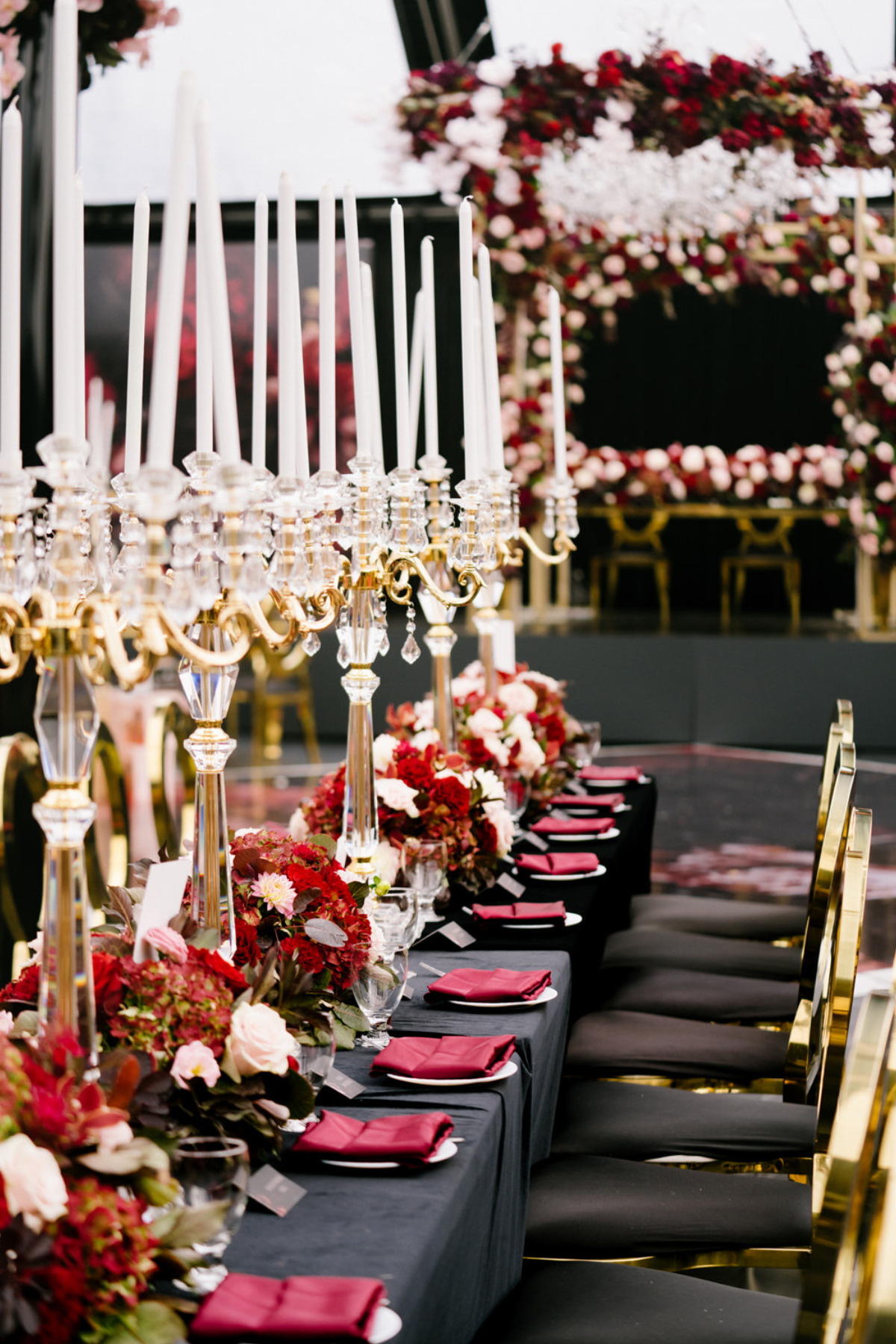 black-gold-burgundy-red-tent-reception-chandeliers-roses-candelabras-centerpiece