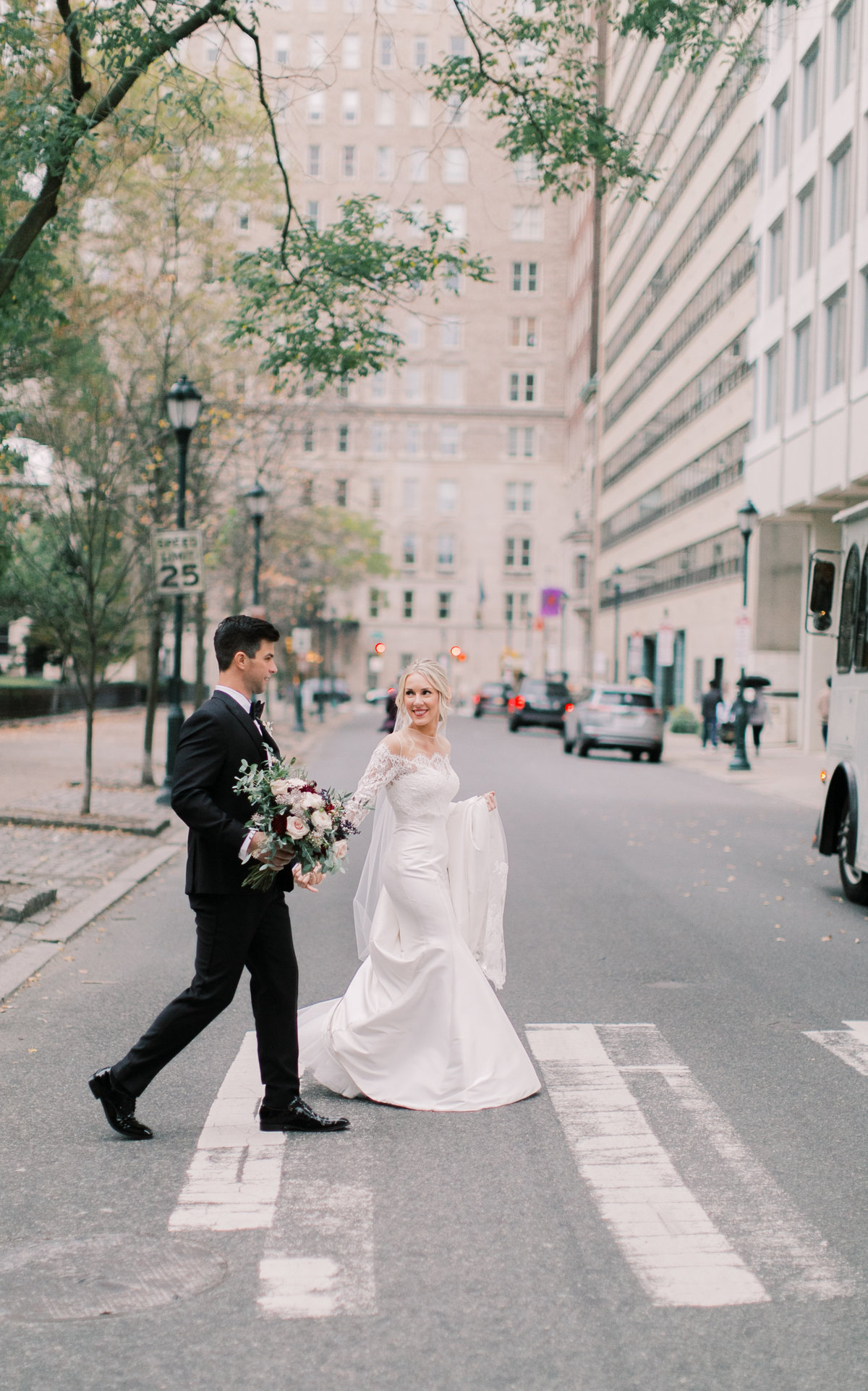 bride and groom walking hand in hand in streets of New York