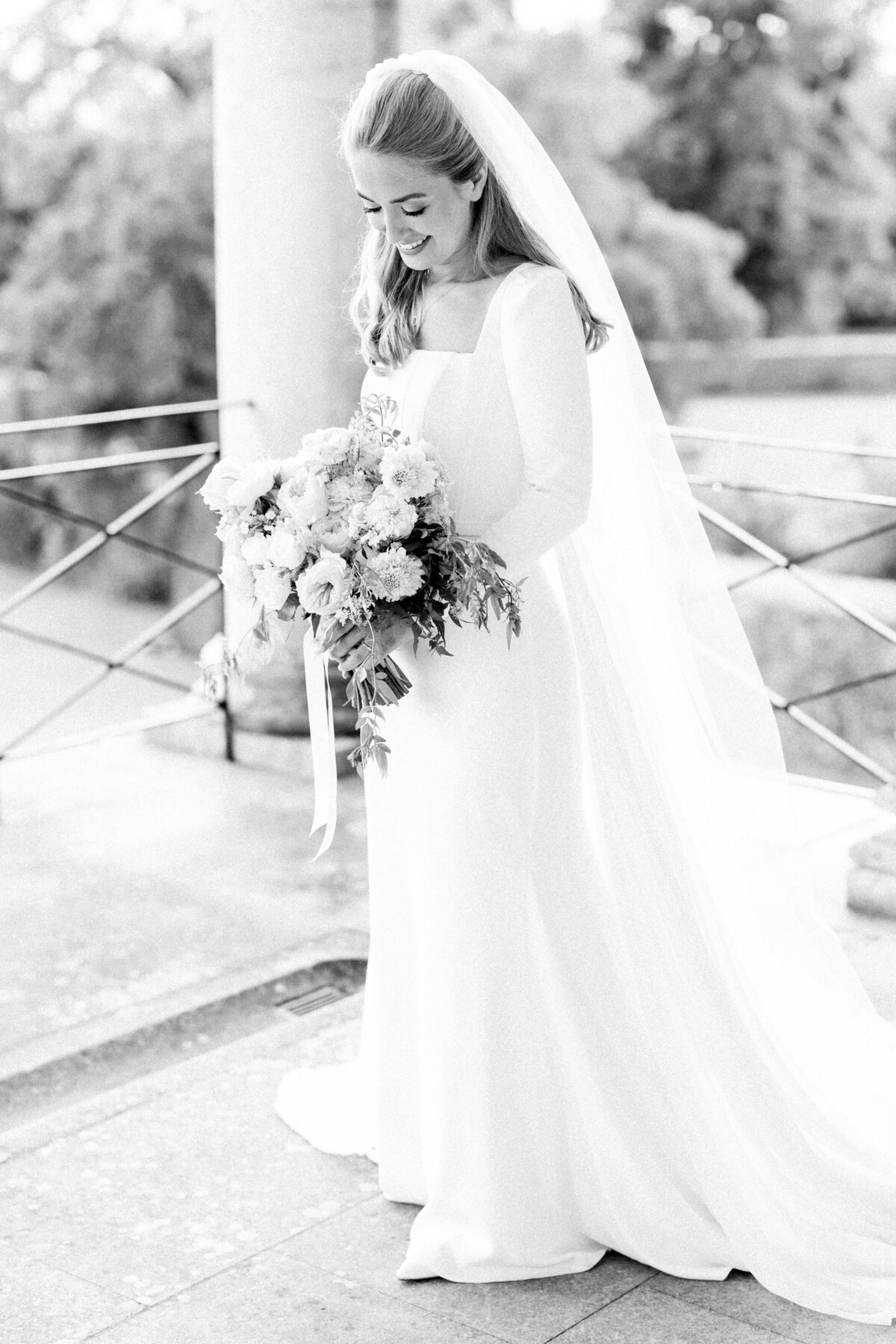 Bride on her wedding day on the Goodwood House balcony