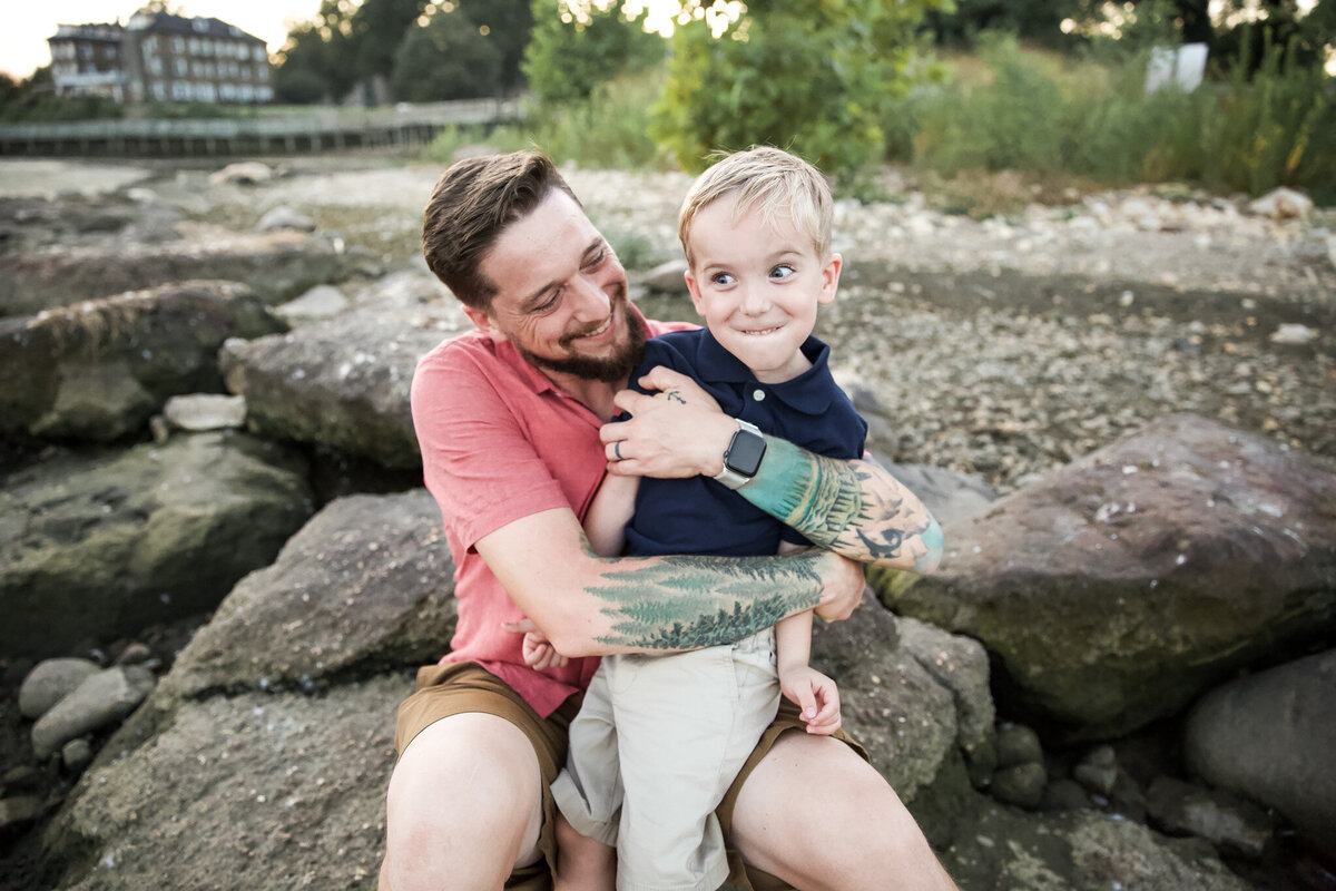 A Baltimore father hugs his son during lifestyle family pictures.