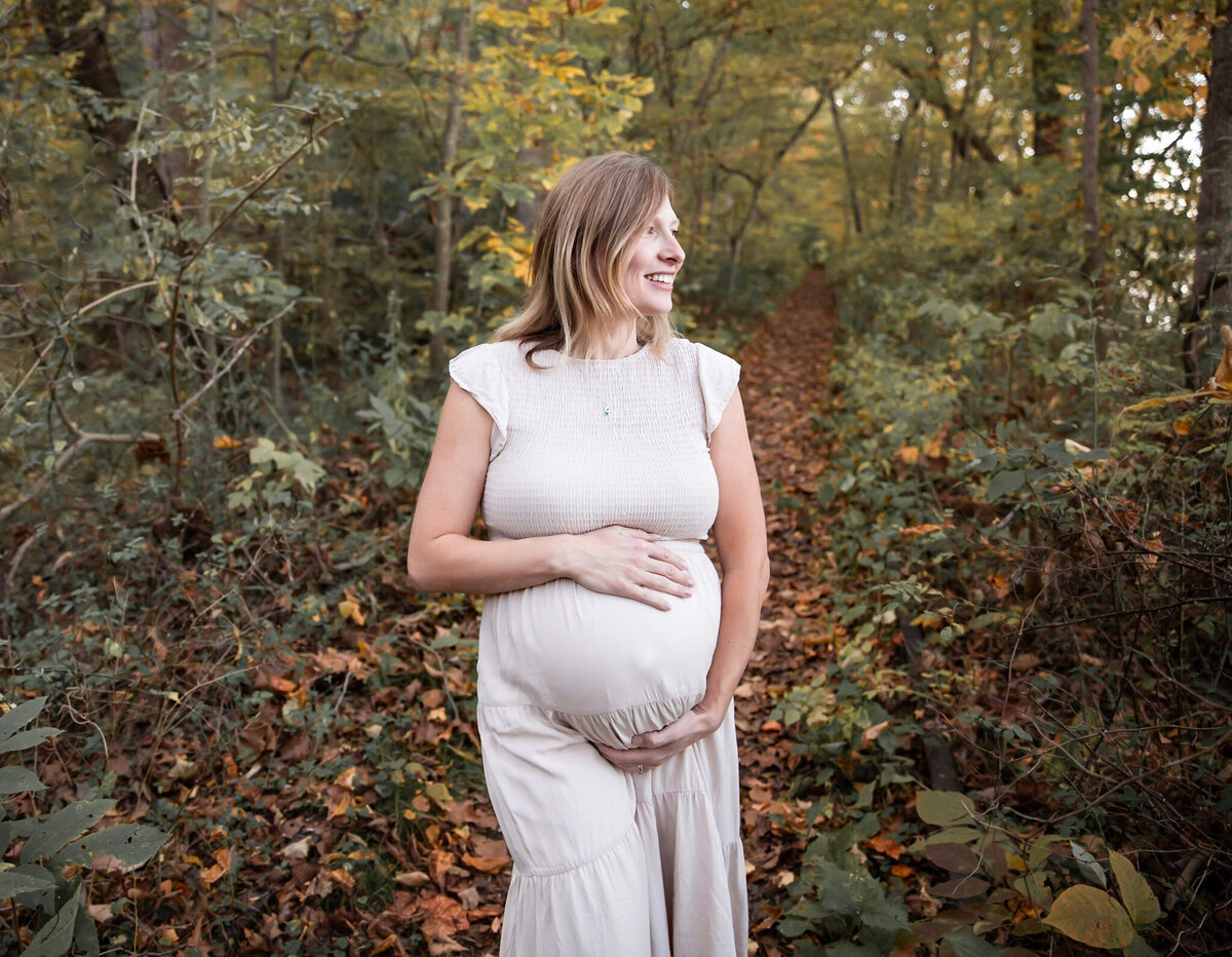 A Mother poses holding her baby bump during her maternity photos in Harford County, Maryland