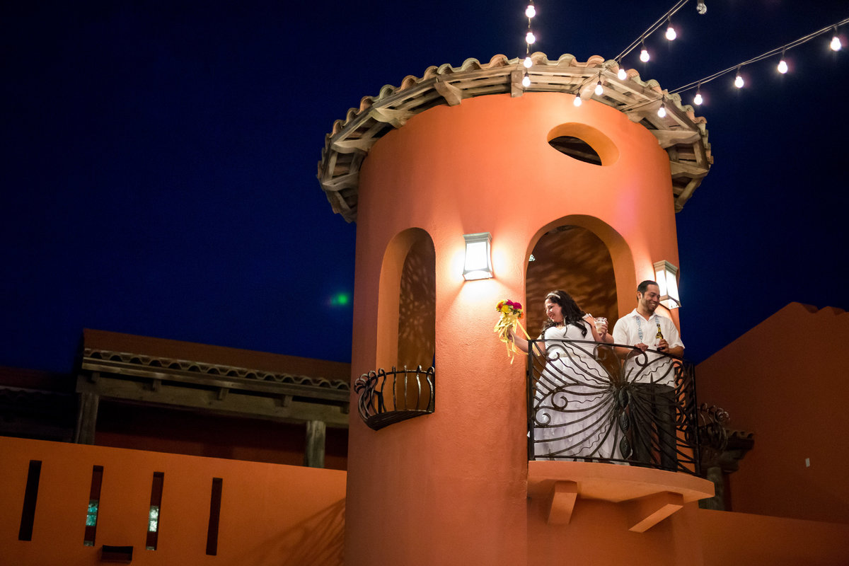 bride and groom toast off balcony of turret at Casa Mariposa reception in South Padre Island Texas