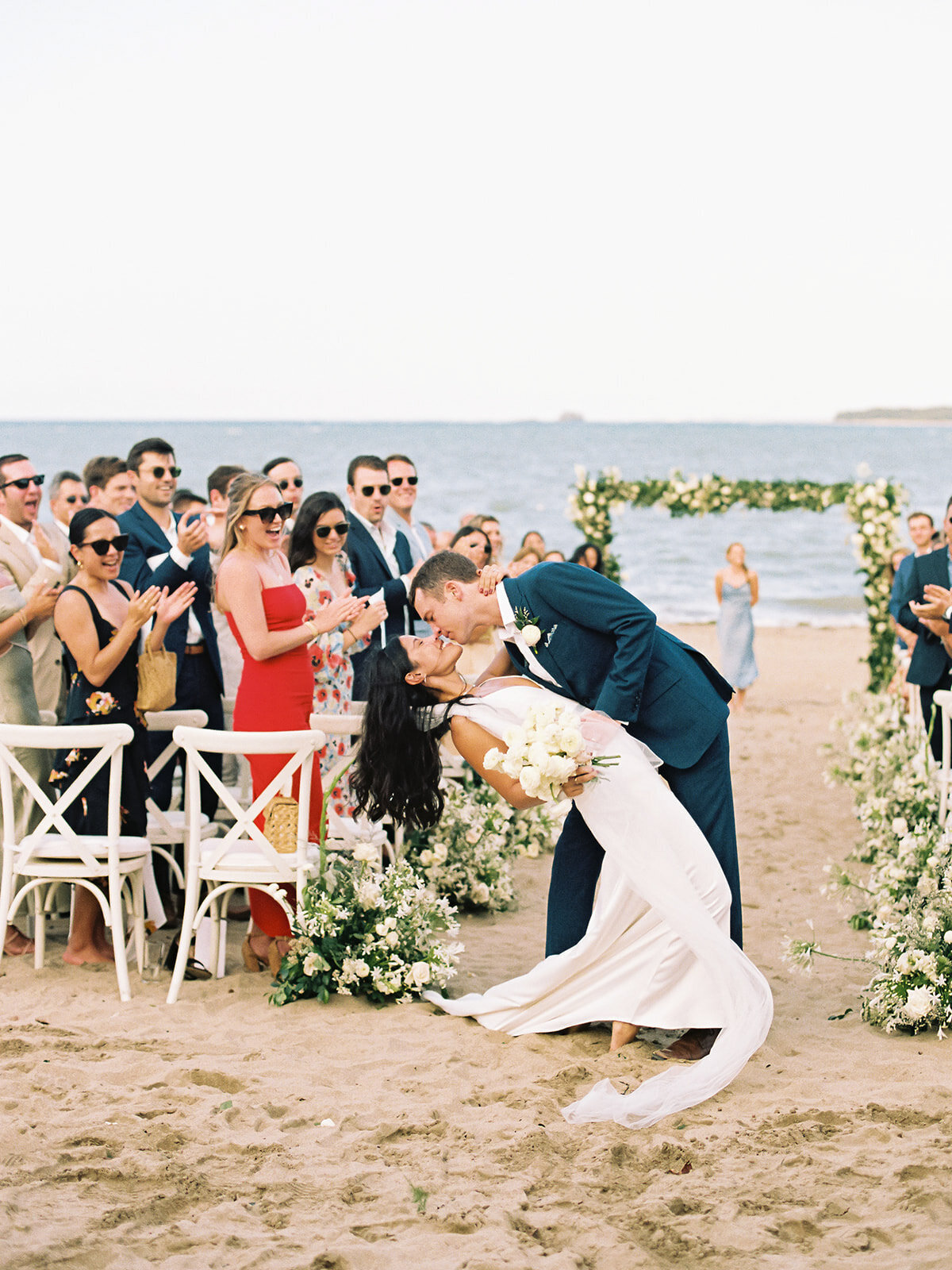 Couple kissing at their destination beach wedding